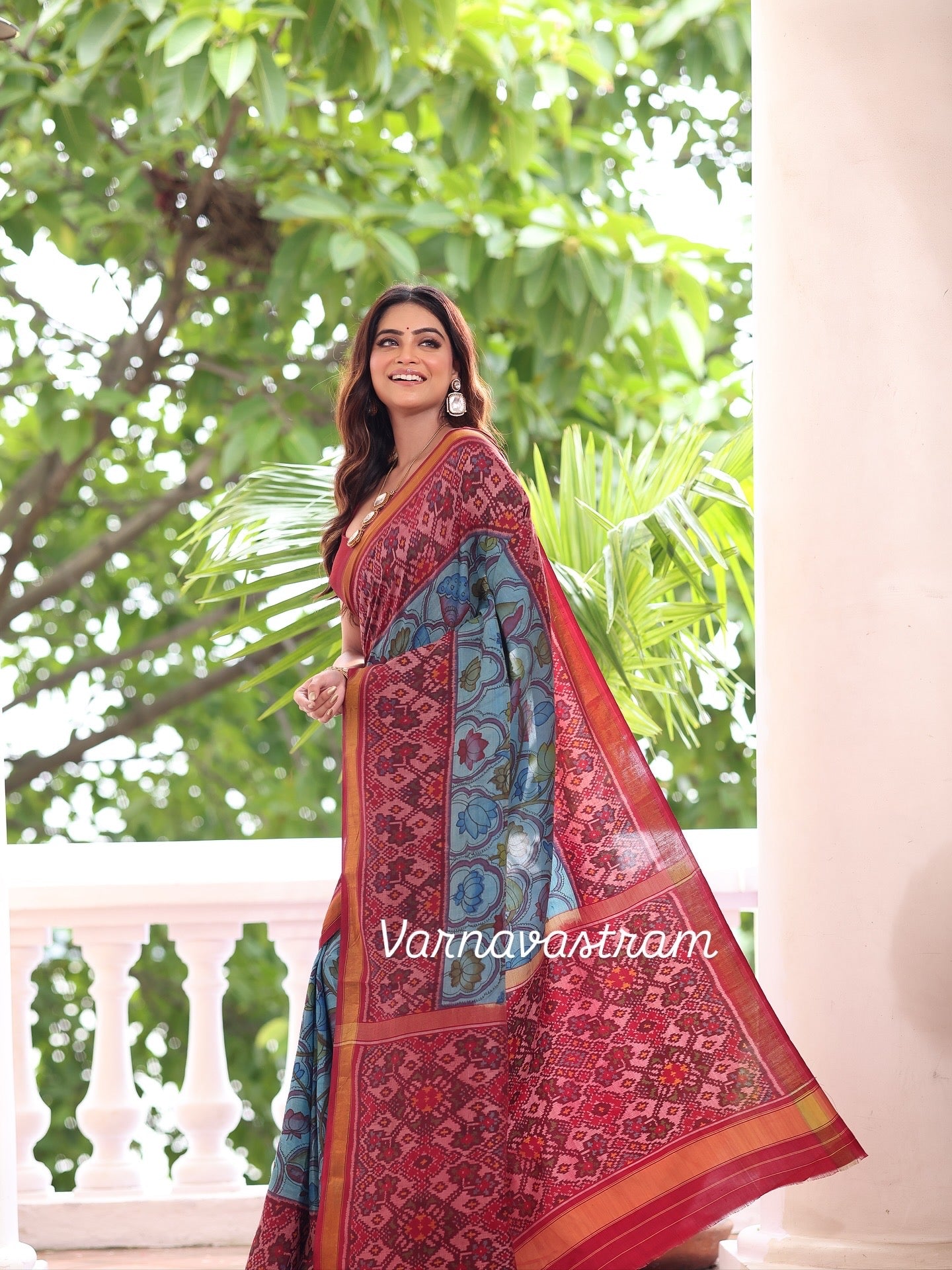 A stunner patola ikkat silk  tie dyed handwoven adorned with Handdrawn handpainted penkalamkari with natural colours on lotus theme