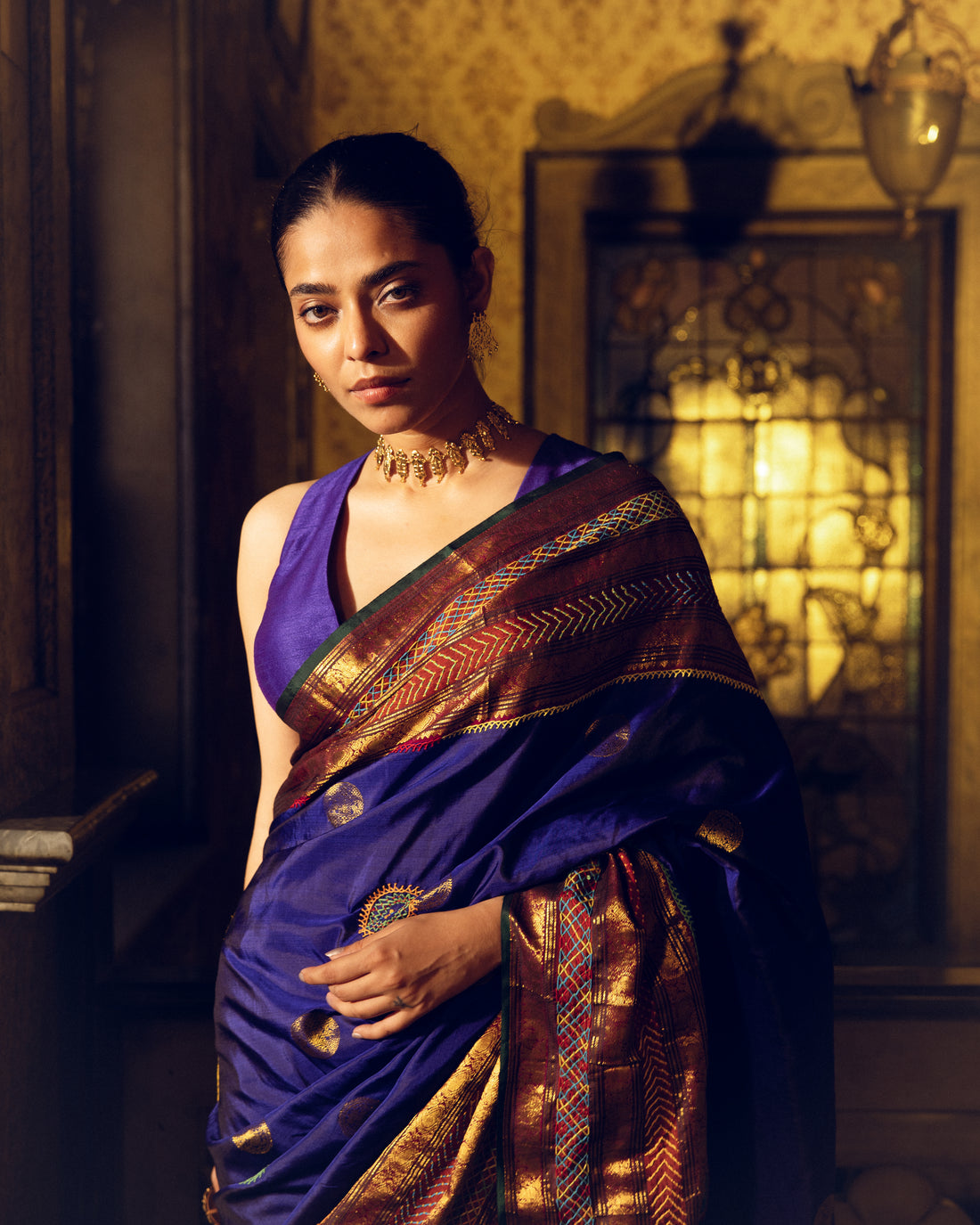 Handwoven pure kanchivaram silk saree blue with purple shot adorned with an exquisite handmade lambani mirror work