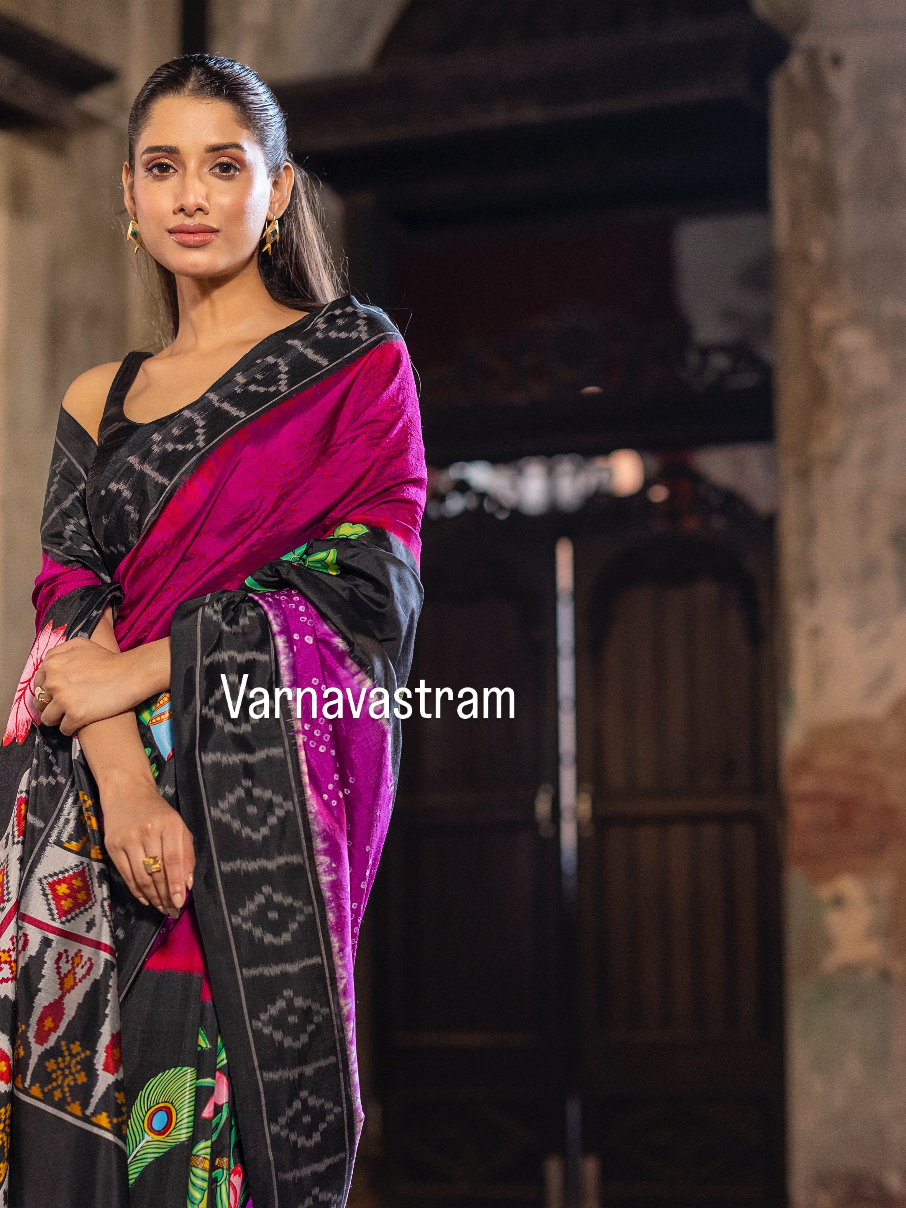 An elegant fusion crafted mulberry silk ikkat saree adorned with pichwai handpainted and tie dyed Bhandej