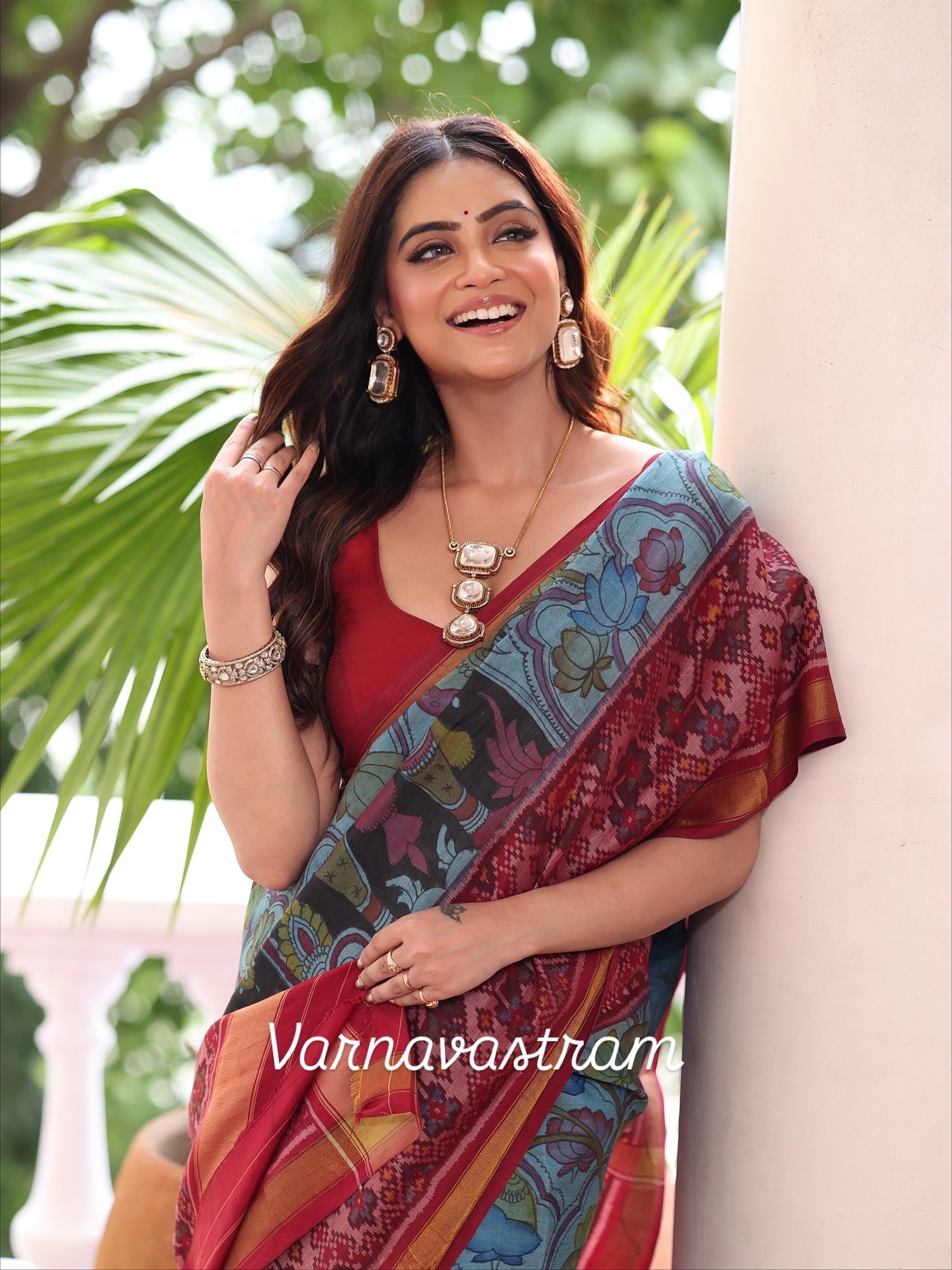 A stunner patola ikkat silk  tie dyed handwoven adorned with Handdrawn handpainted penkalamkari with natural colours on lotus theme