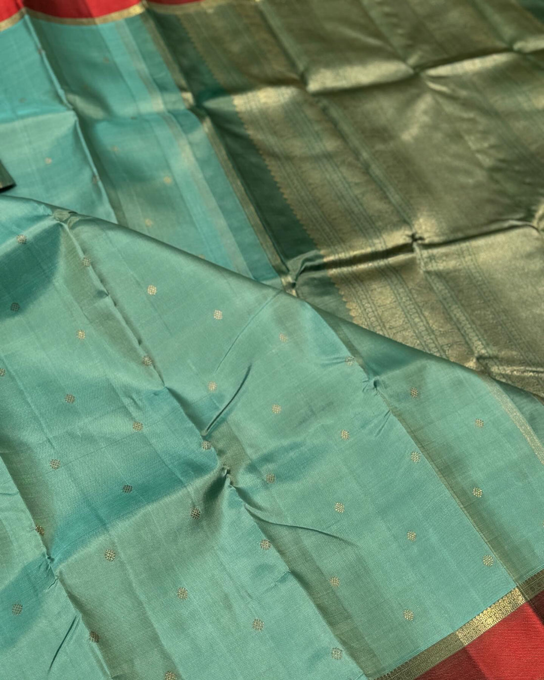A gorgeous cyan green with red threadwork and zari border kanchivaram silk SAREE