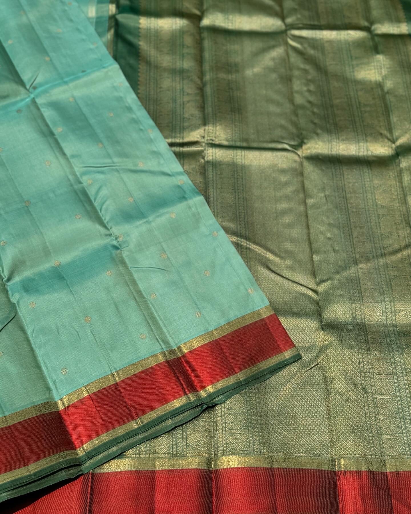 A gorgeous cyan green with red threadwork and zari border kanchivaram silk SAREE
