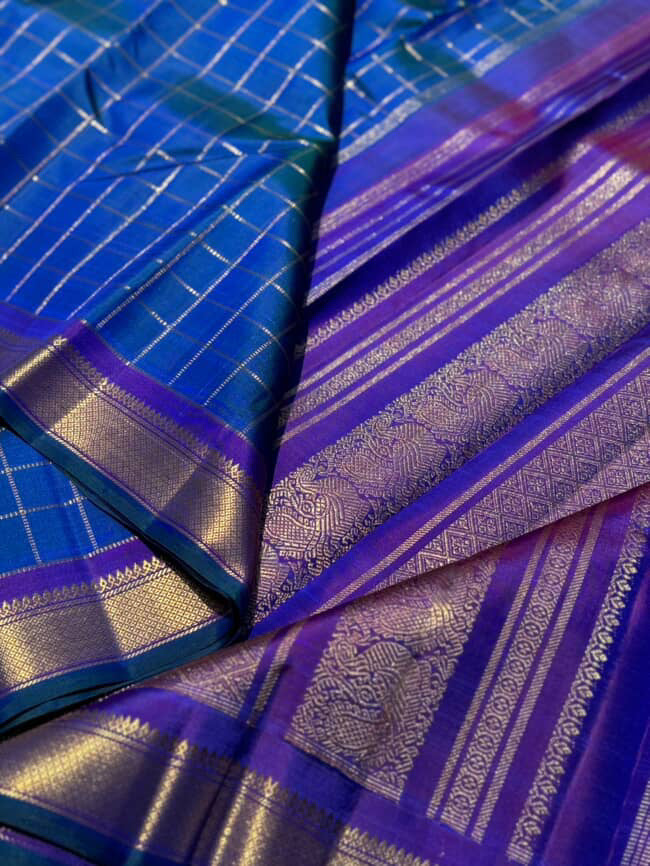 A stunner muthuseer zari kattam kanchivaram silk saree pure handwoven in a peacock blue