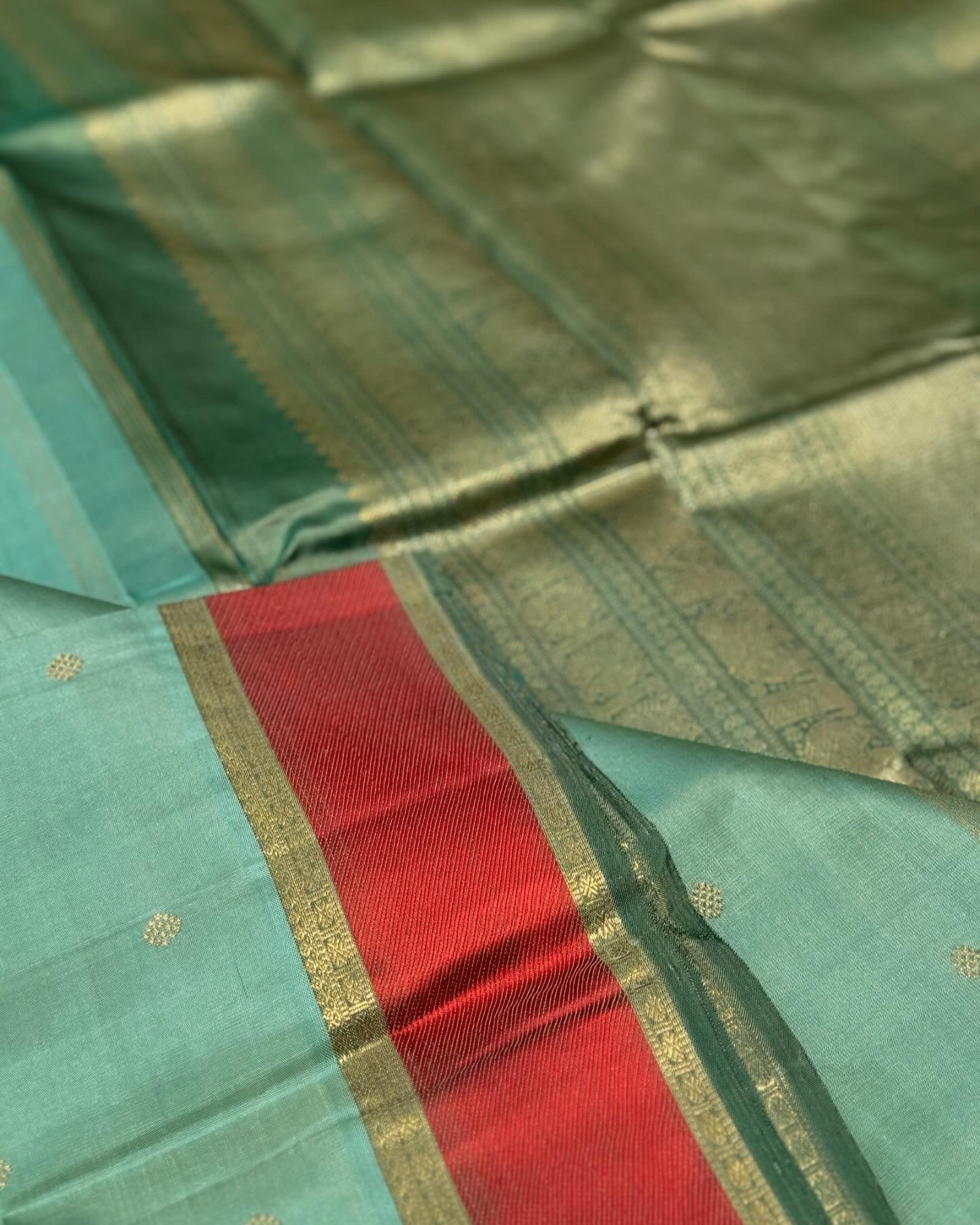 A gorgeous cyan green with red threadwork and zari border kanchivaram silk SAREE