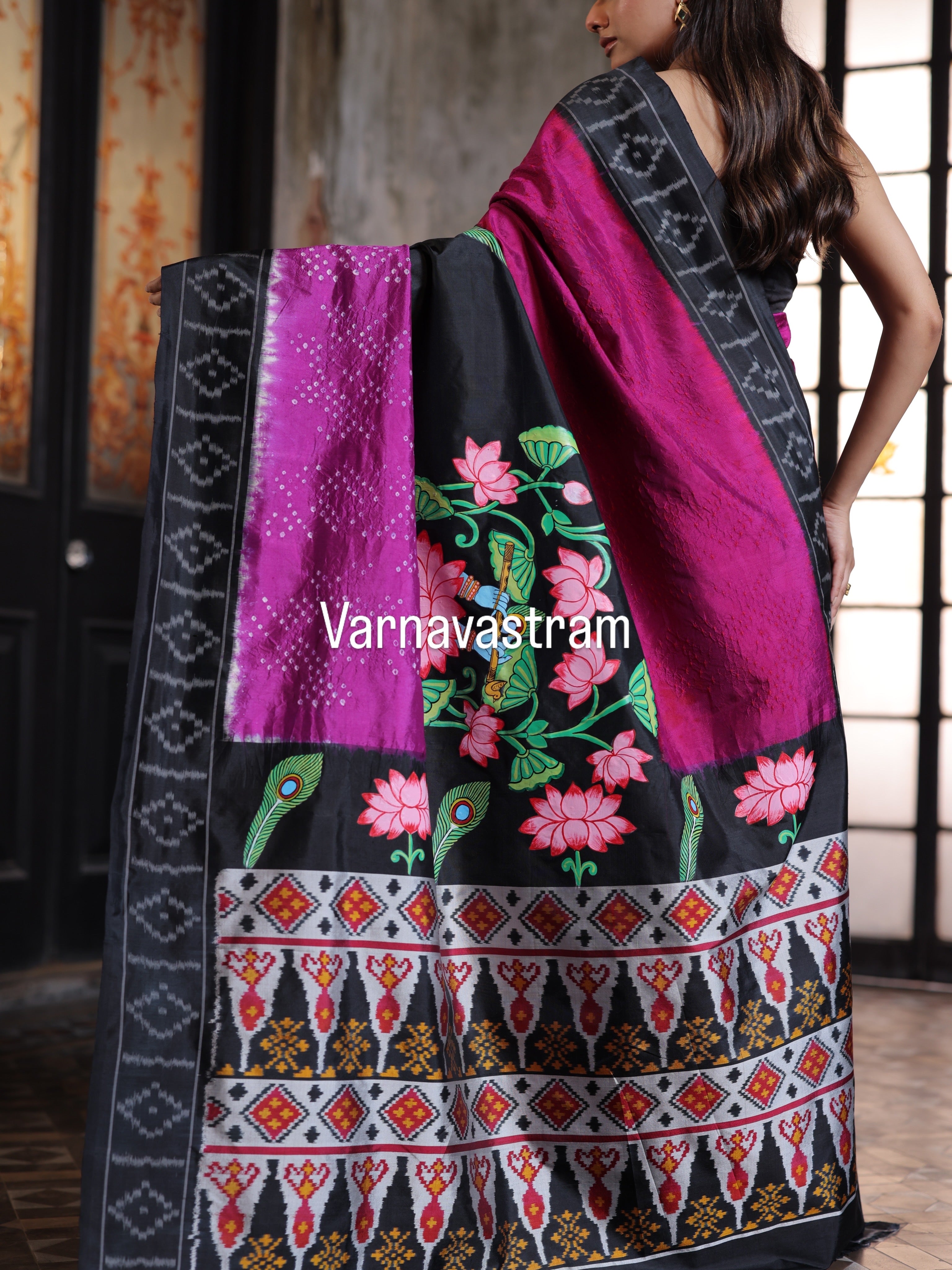 An elegant fusion crafted mulberry silk ikkat saree adorned with pichwai handpainted and tie dyed Bhandej