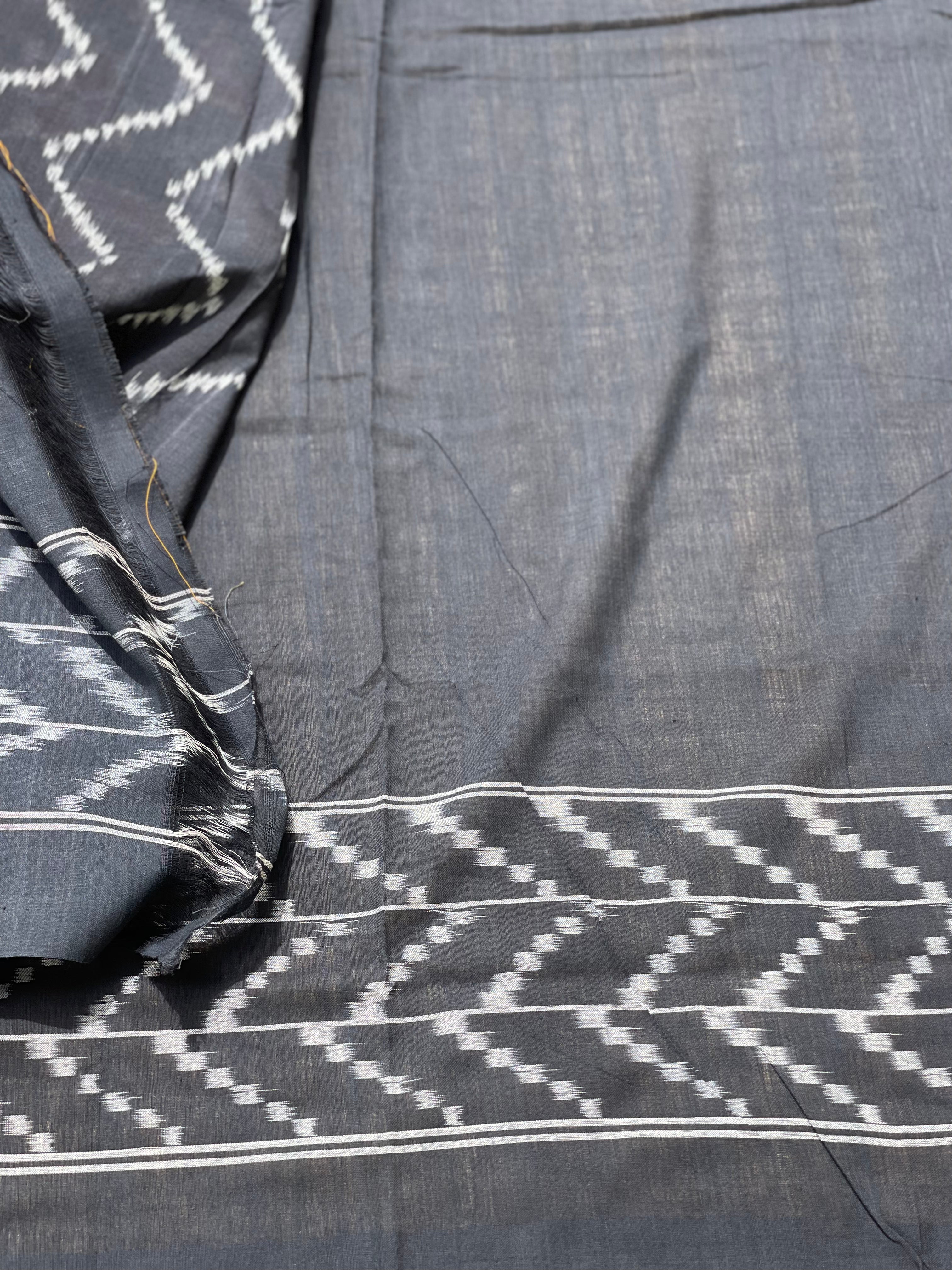A Red checkered weft ikkat cotton Saree with chevron black border