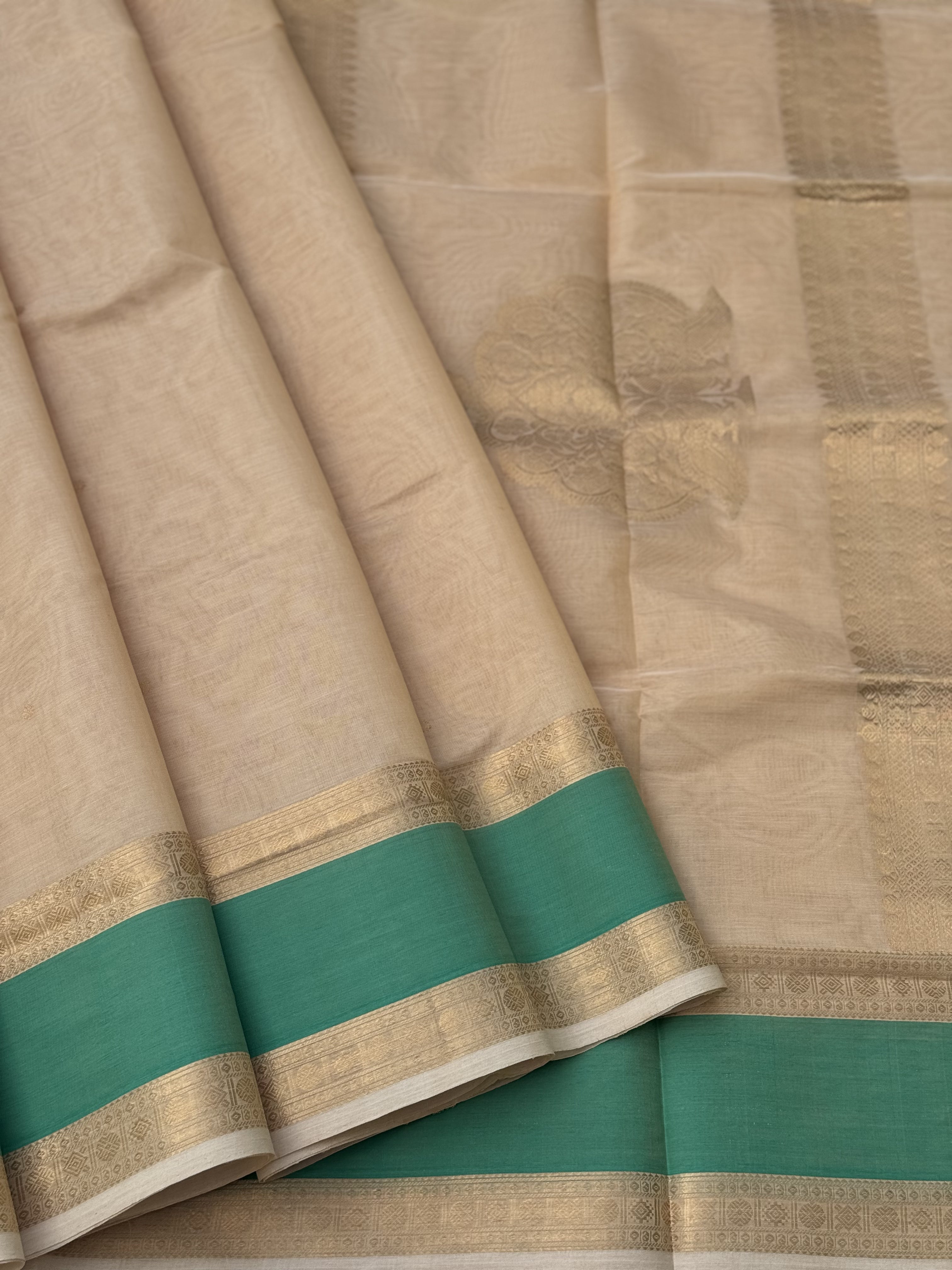 A gorgeous ivory gold shade handwoven Kanchi silk cotton saree