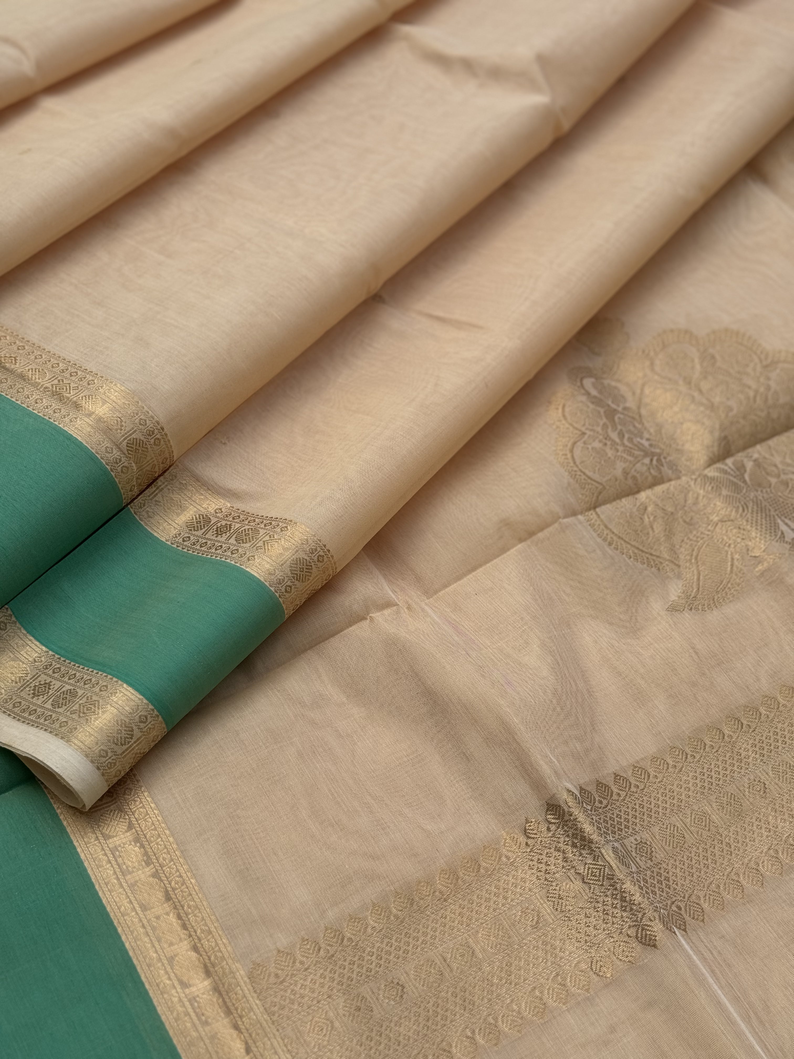 A gorgeous ivory gold shade handwoven Kanchi silk cotton saree