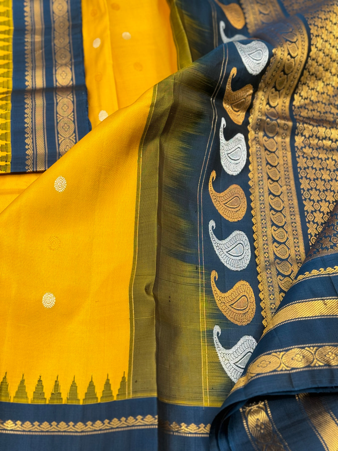 A gorgeous peacock blue with yellow handwoven gadwal silk saree