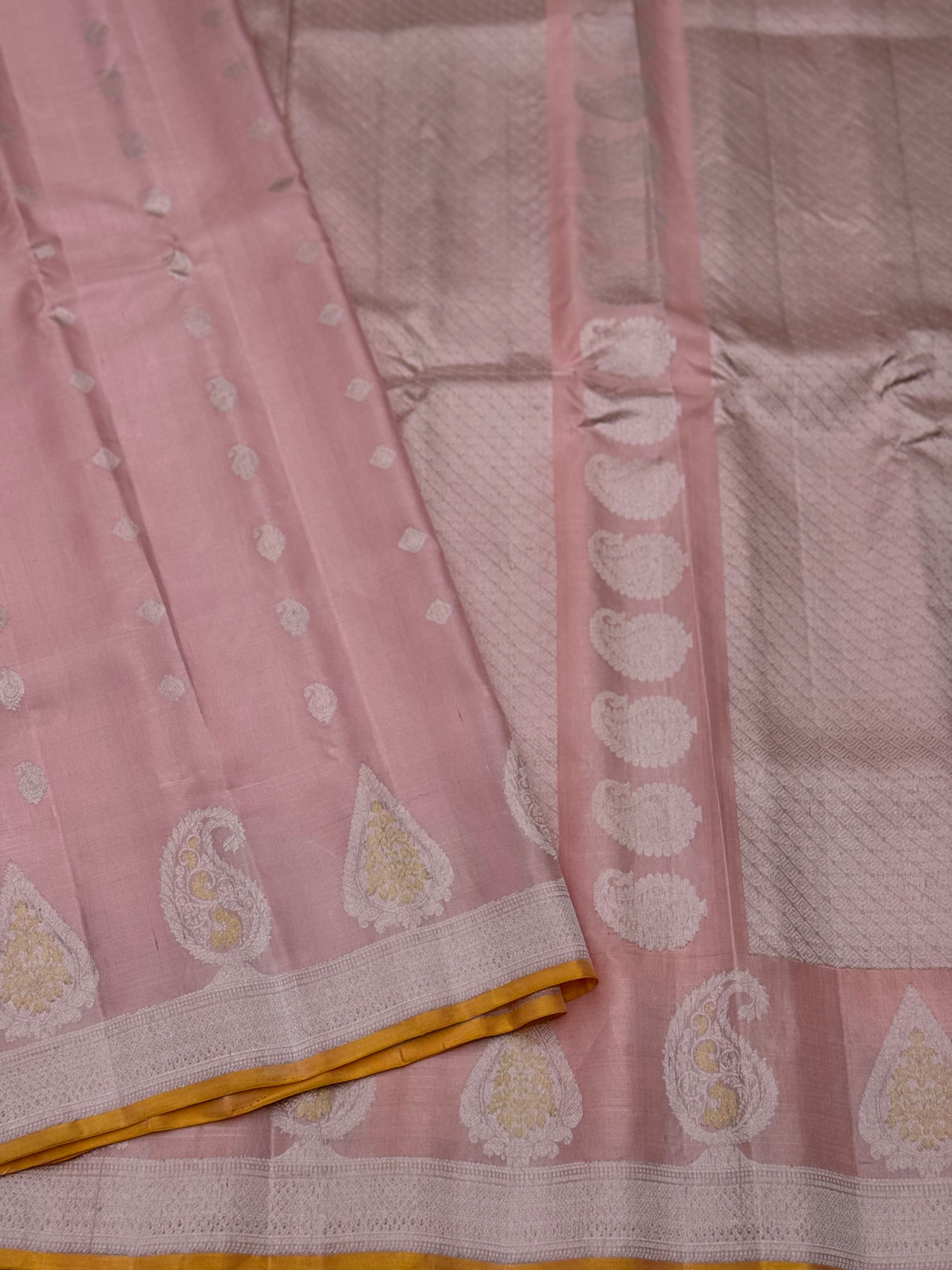 A gorgeous pastel baby pink with orange yellow handwoven gadwal silk saree