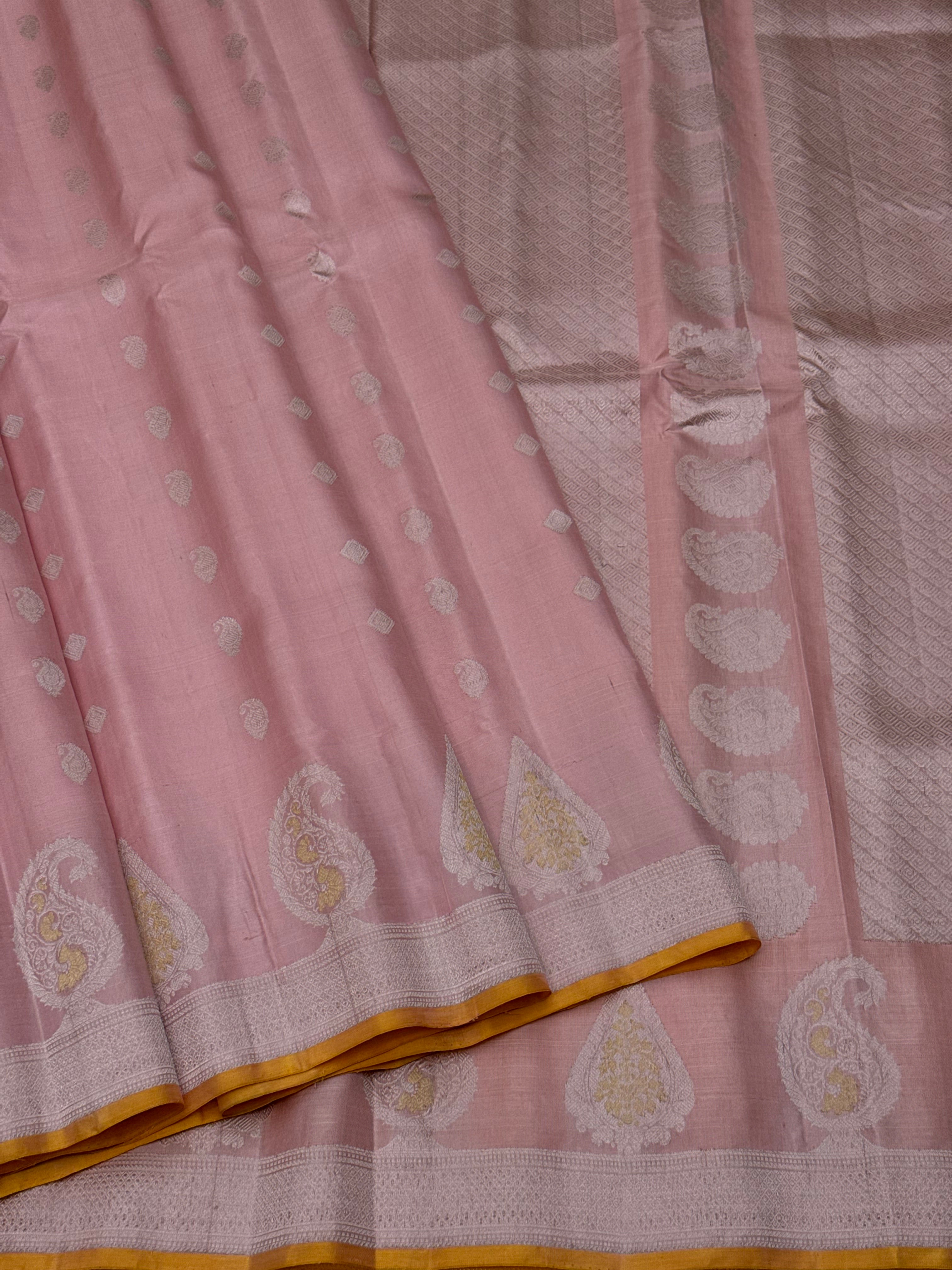 A gorgeous pastel baby pink with orange yellow handwoven gadwal silk saree