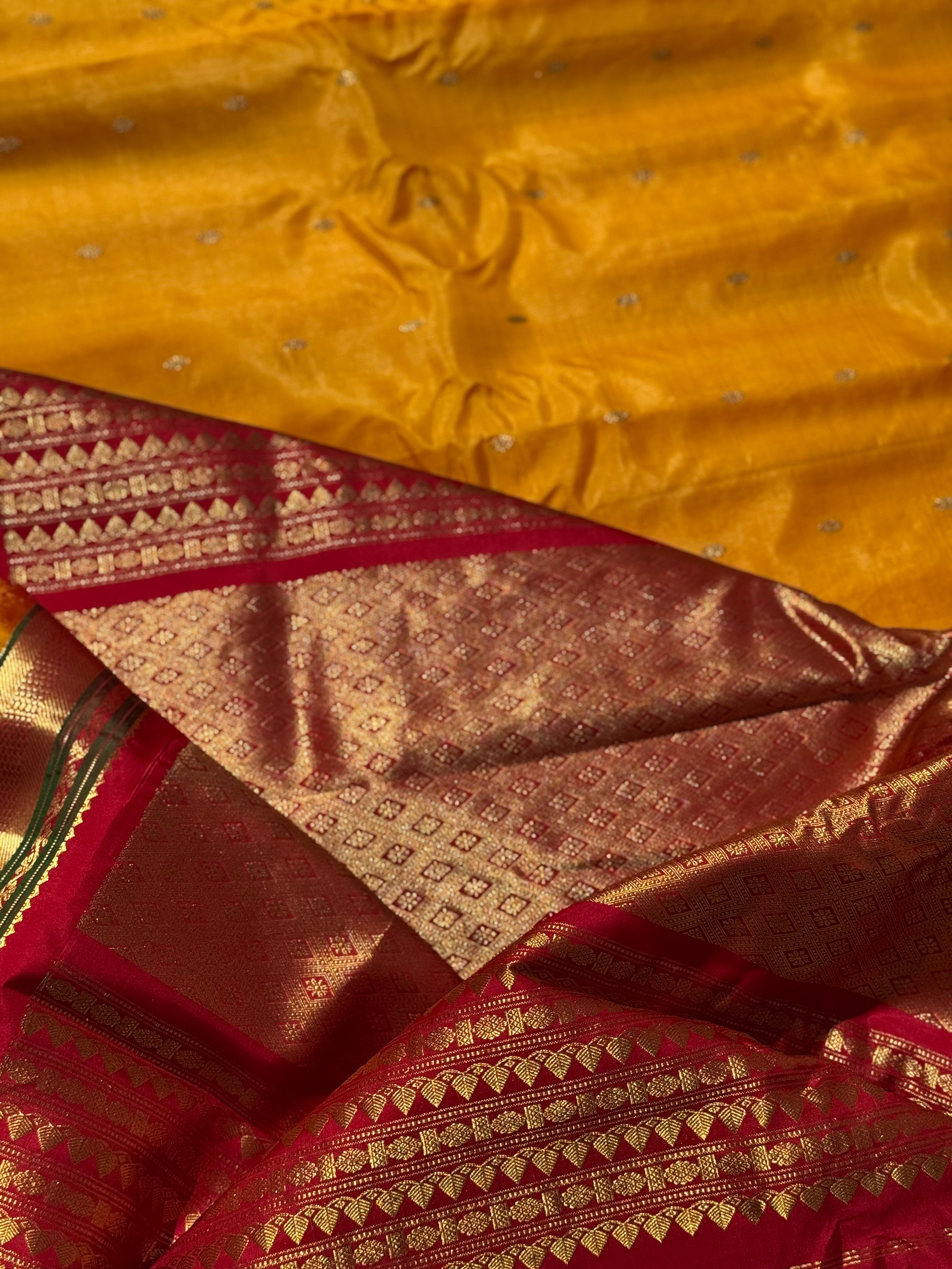 A gorgeous turmeric yellow with red temple border kuttu handwoven gadwal silk saree