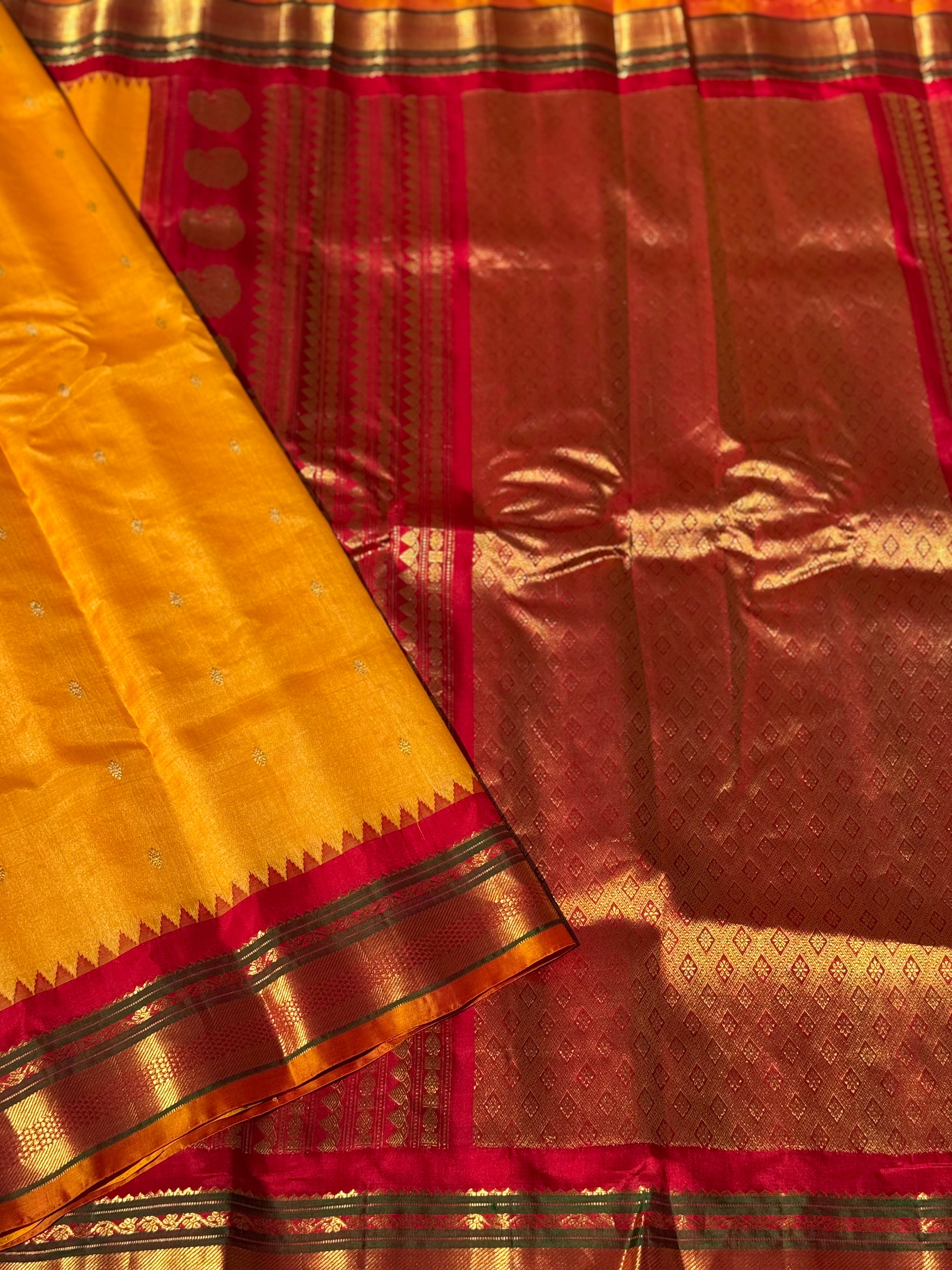 A gorgeous turmeric yellow with red temple border kuttu handwoven gadwal silk saree