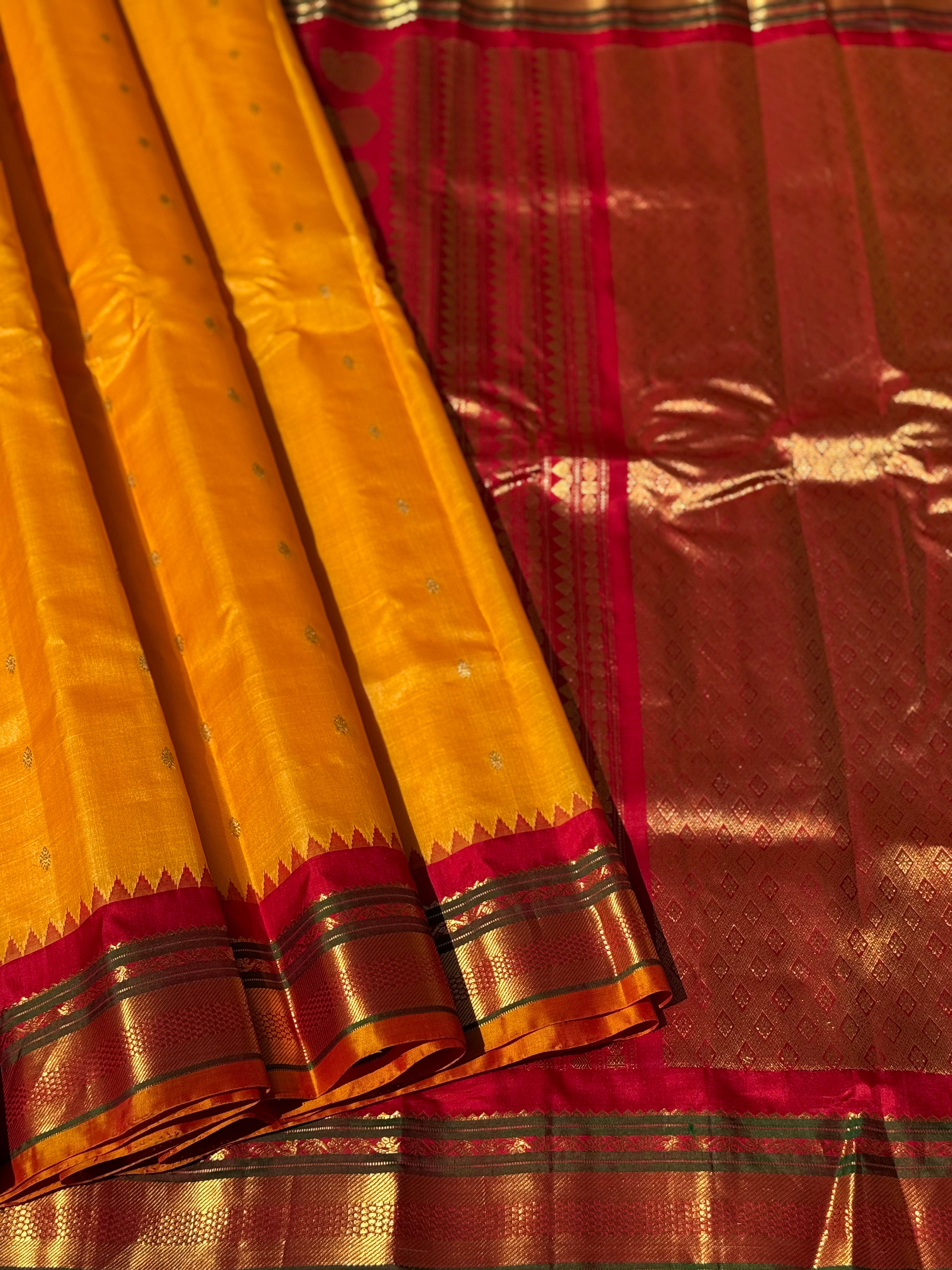 A gorgeous turmeric yellow with red temple border kuttu handwoven gadwal silk saree