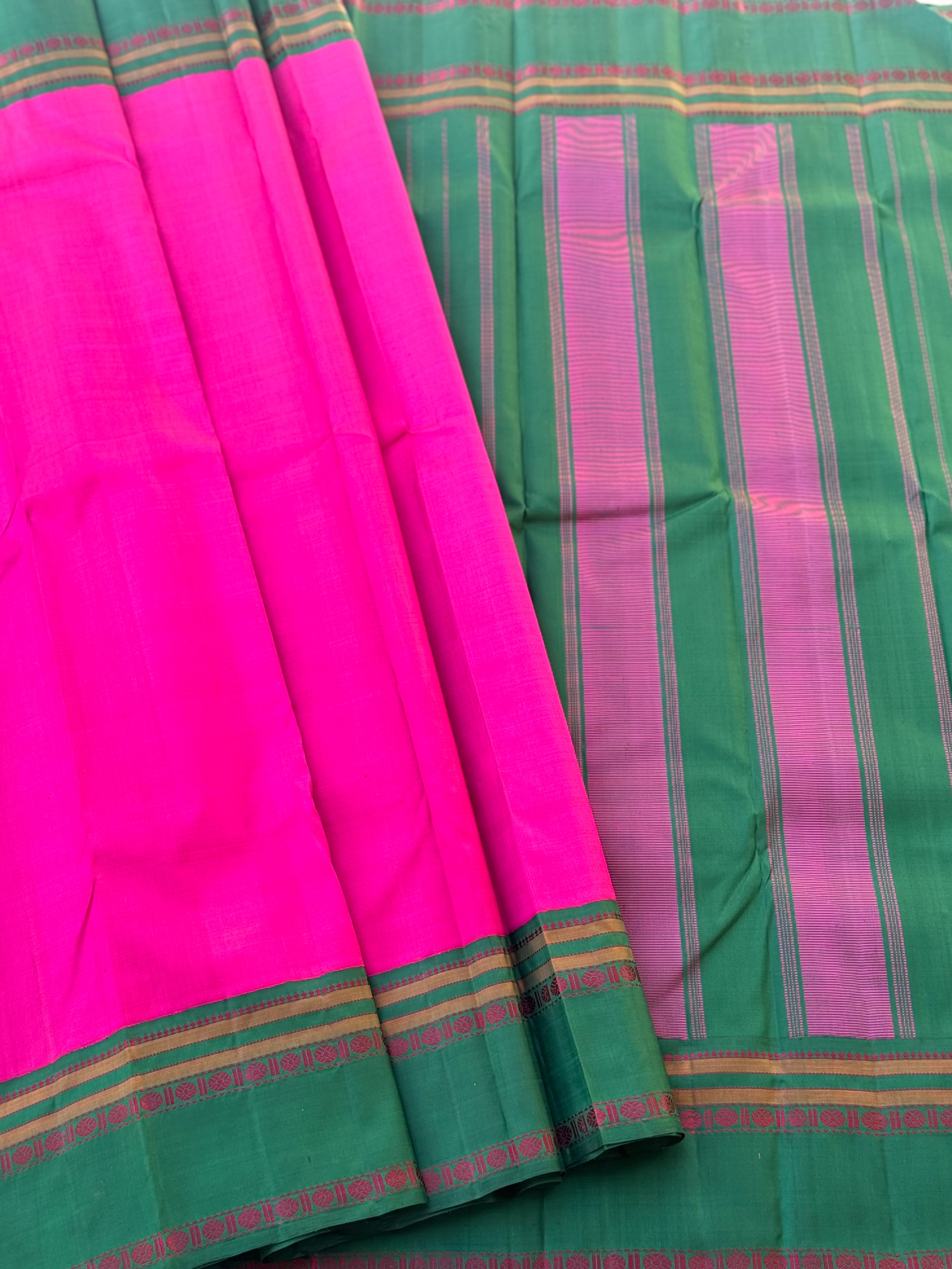 A subtle handwoven pattu rose pink shade with green Threadwork Kai korvai kanchivaram silk saree