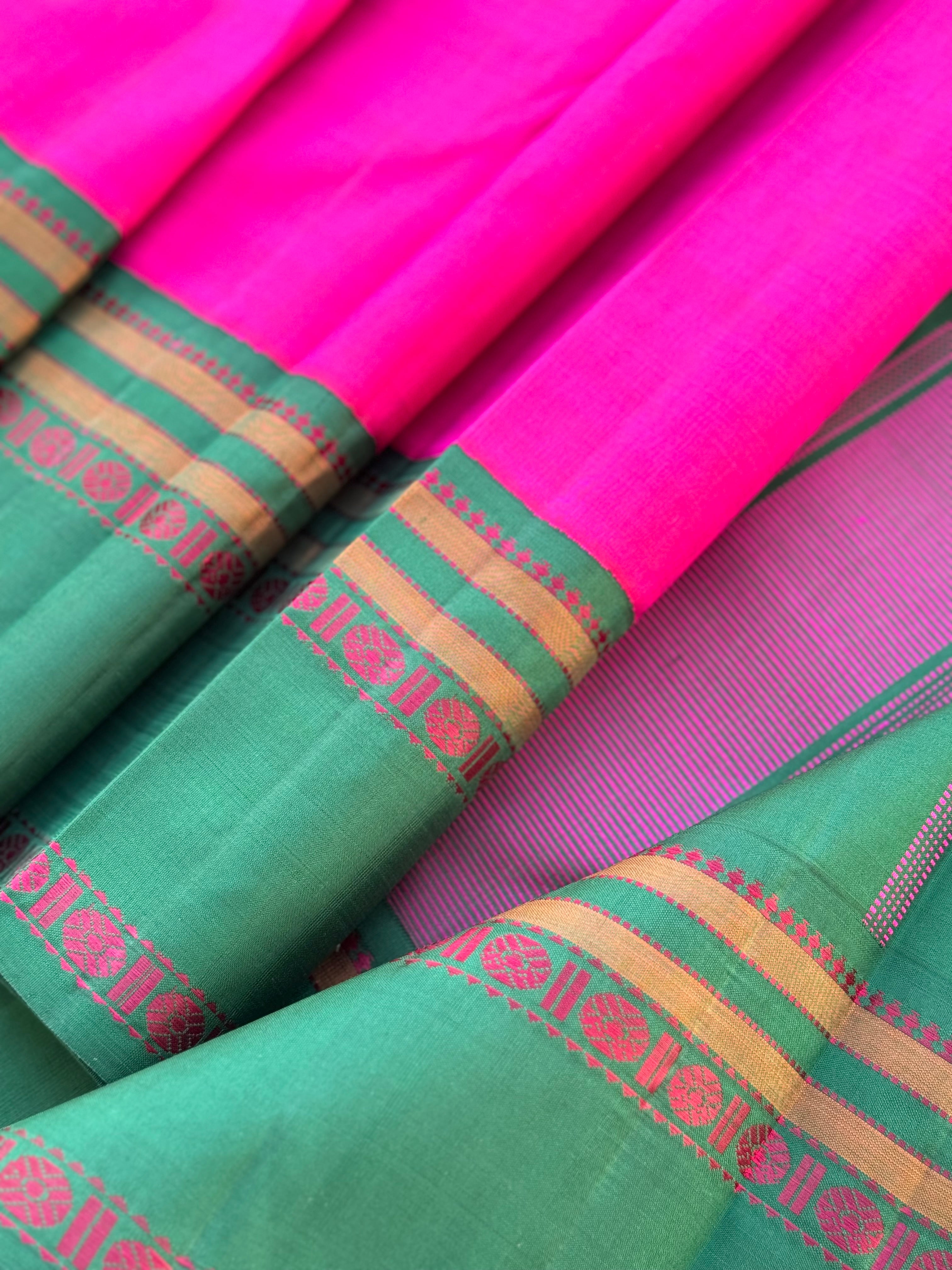 A subtle handwoven pattu rose pink shade with green Threadwork Kai korvai kanchivaram silk saree