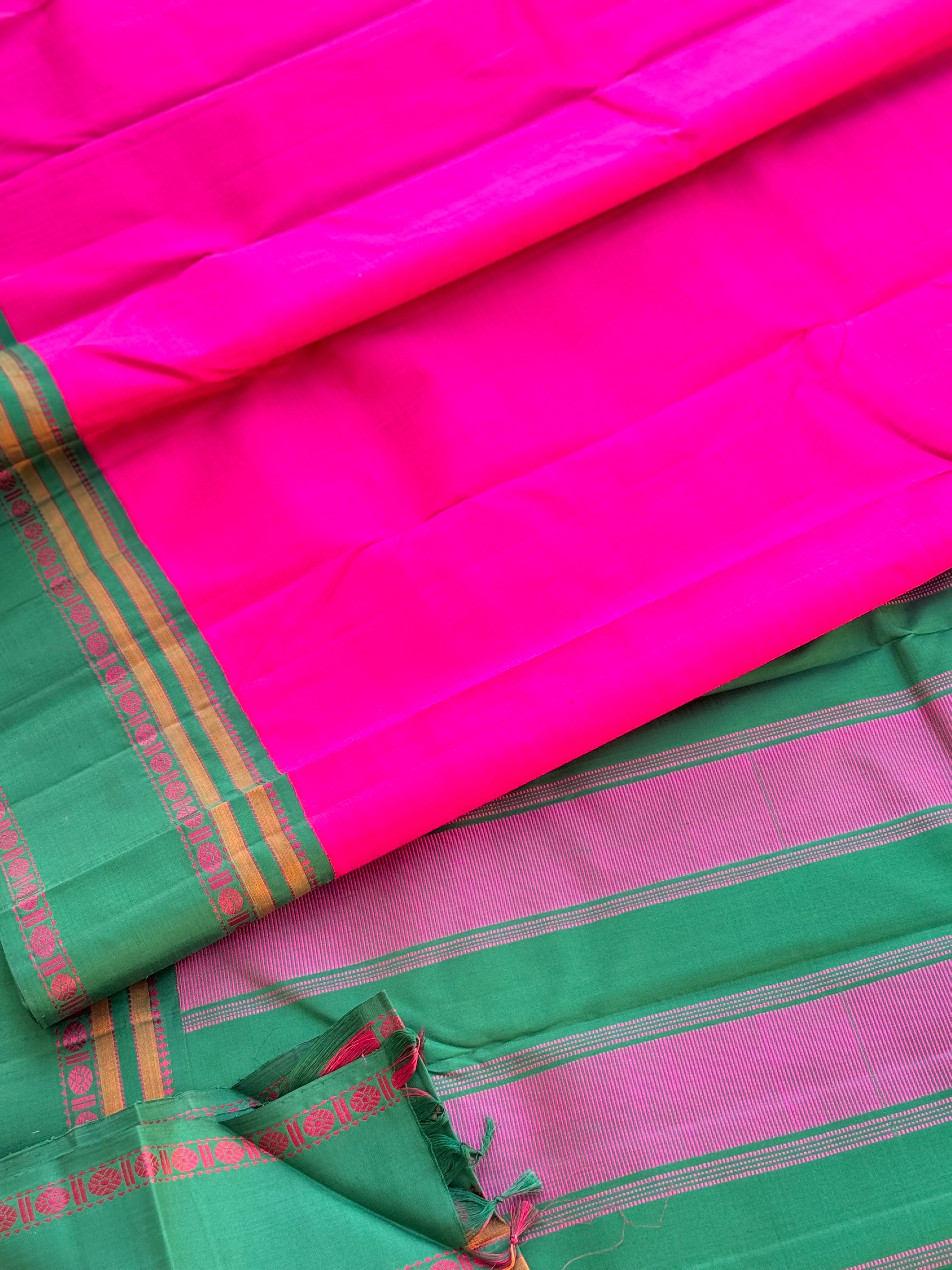 A subtle handwoven pattu rose pink shade with green Threadwork Kai korvai kanchivaram silk saree