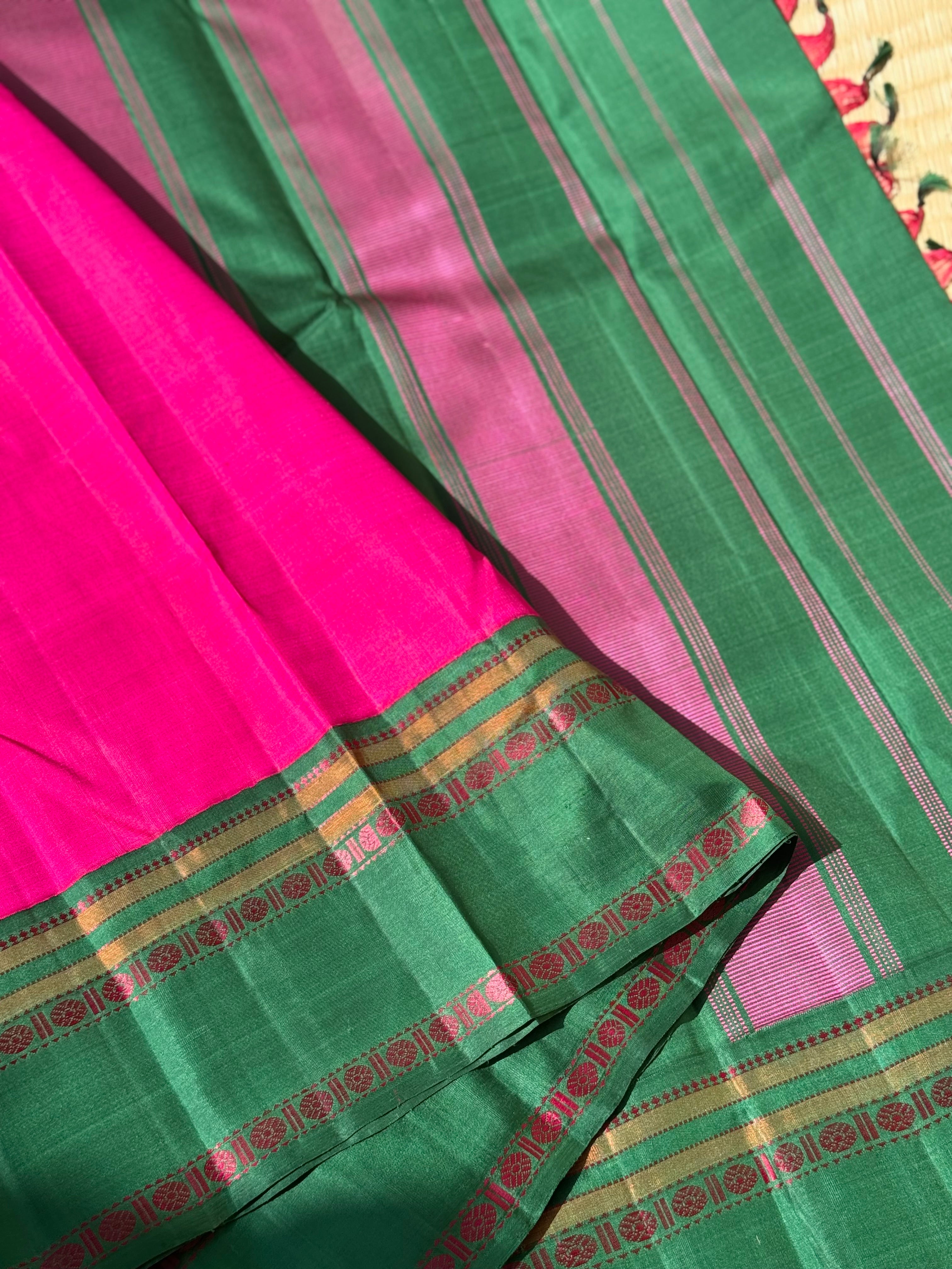 A subtle handwoven pattu rose pink shade with green Threadwork Kai korvai kanchivaram silk saree