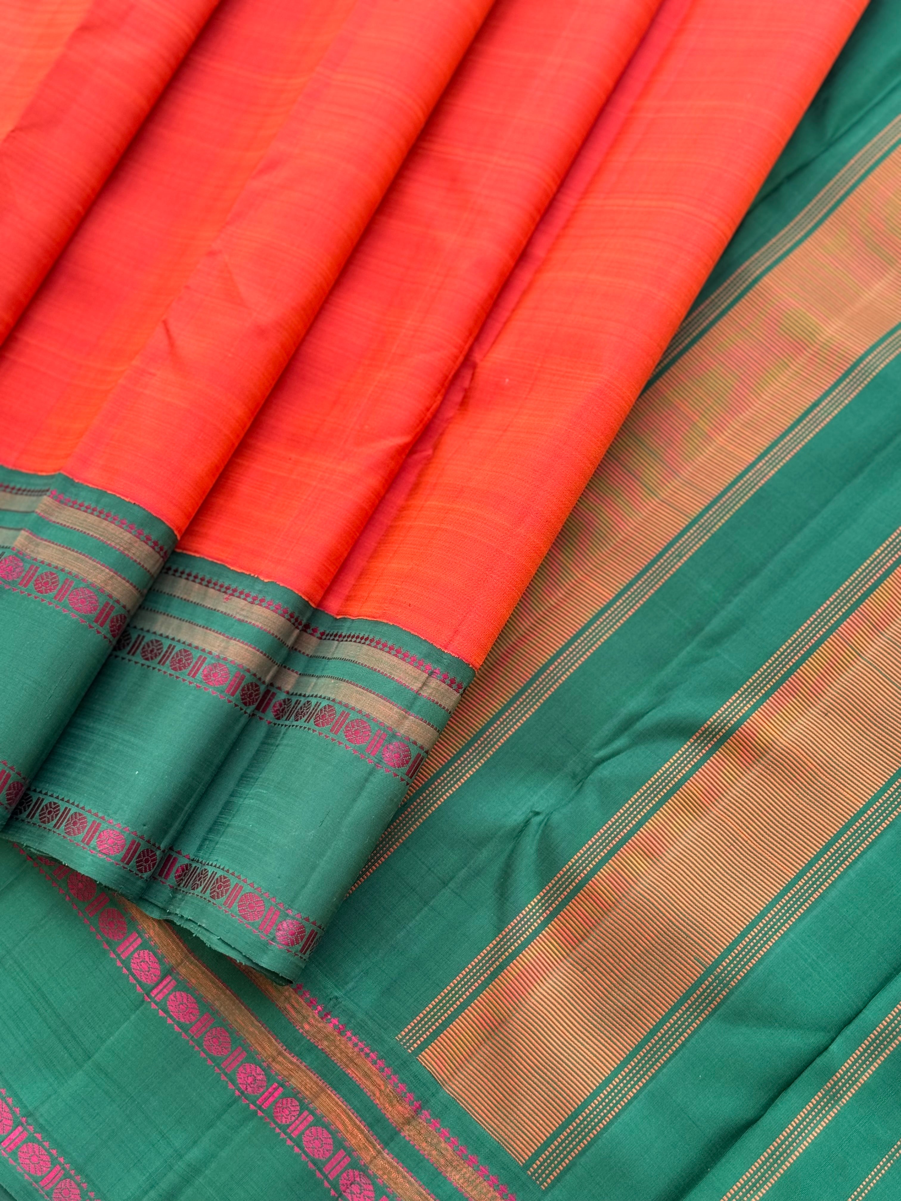 A subtle handwoven dark peach shade with green Threadwork Kai korvai kanchivaram silk saree