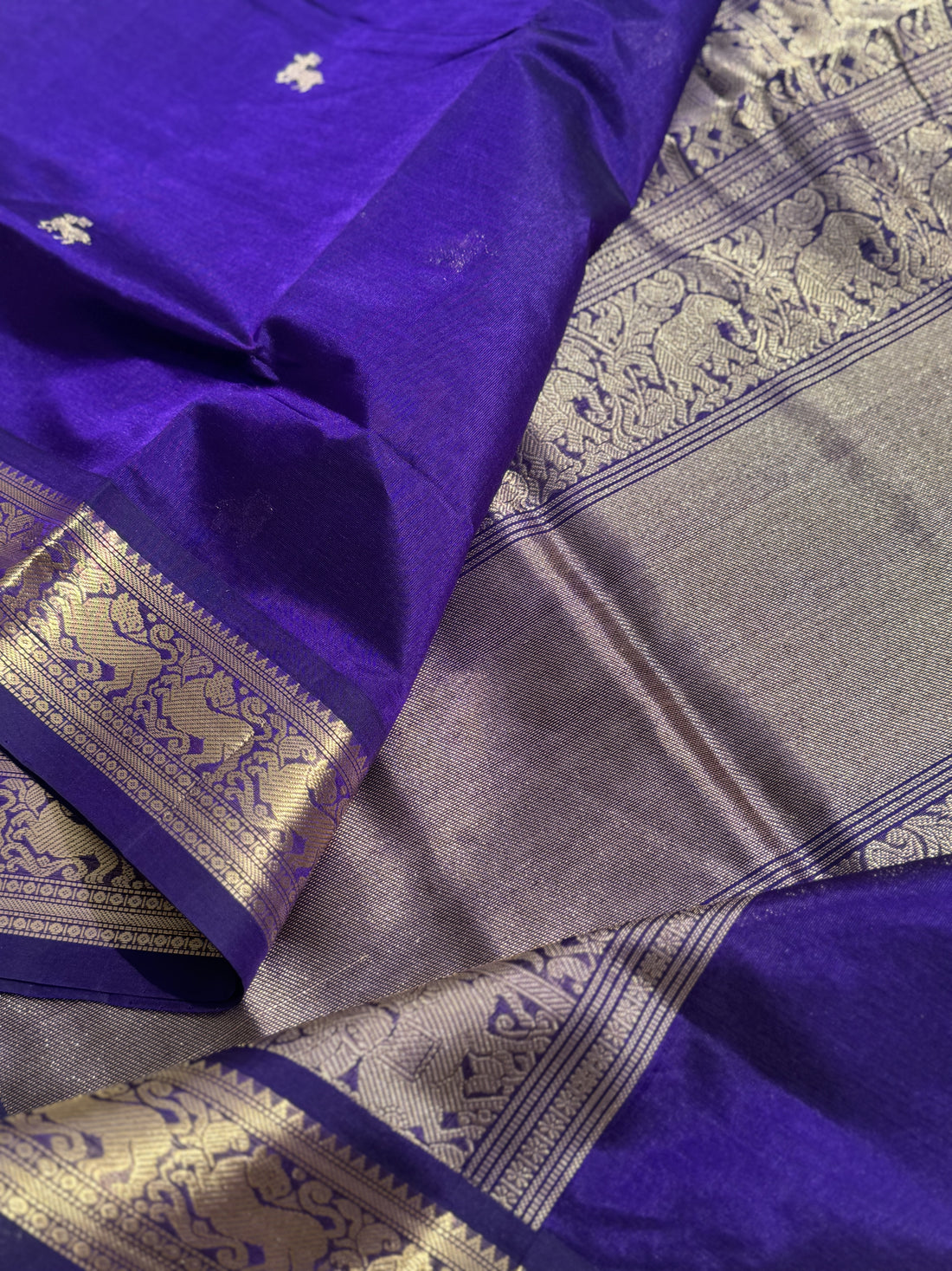 A gorgeous purple blue shade handwoven Kanchi silk cotton saree with zari motifs