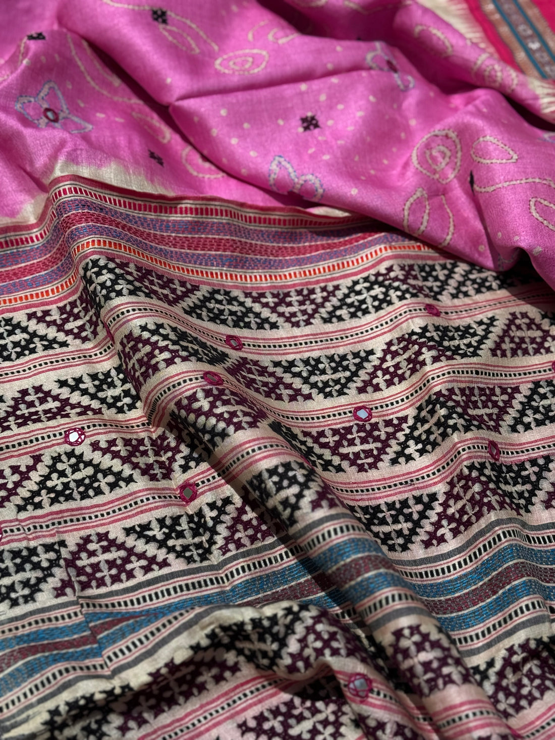 An exquisite handwoven vidharbha tussar silk saree with karvati kinar border intricately tie dyed with pink bhandhej and kutch hand embroidered