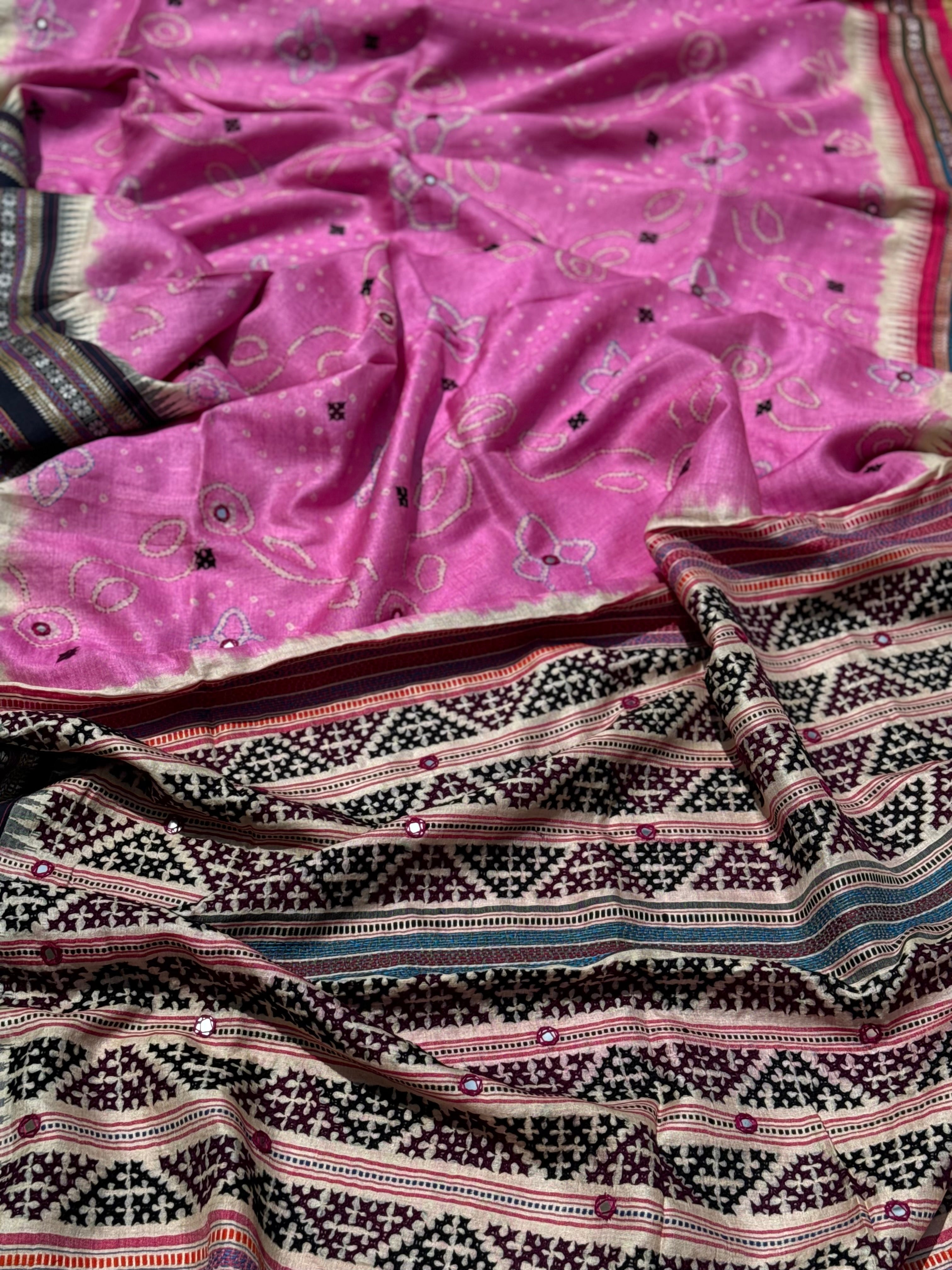 An exquisite handwoven vidharbha tussar silk saree with karvati kinar border intricately tie dyed with pink bhandhej and kutch hand embroidered
