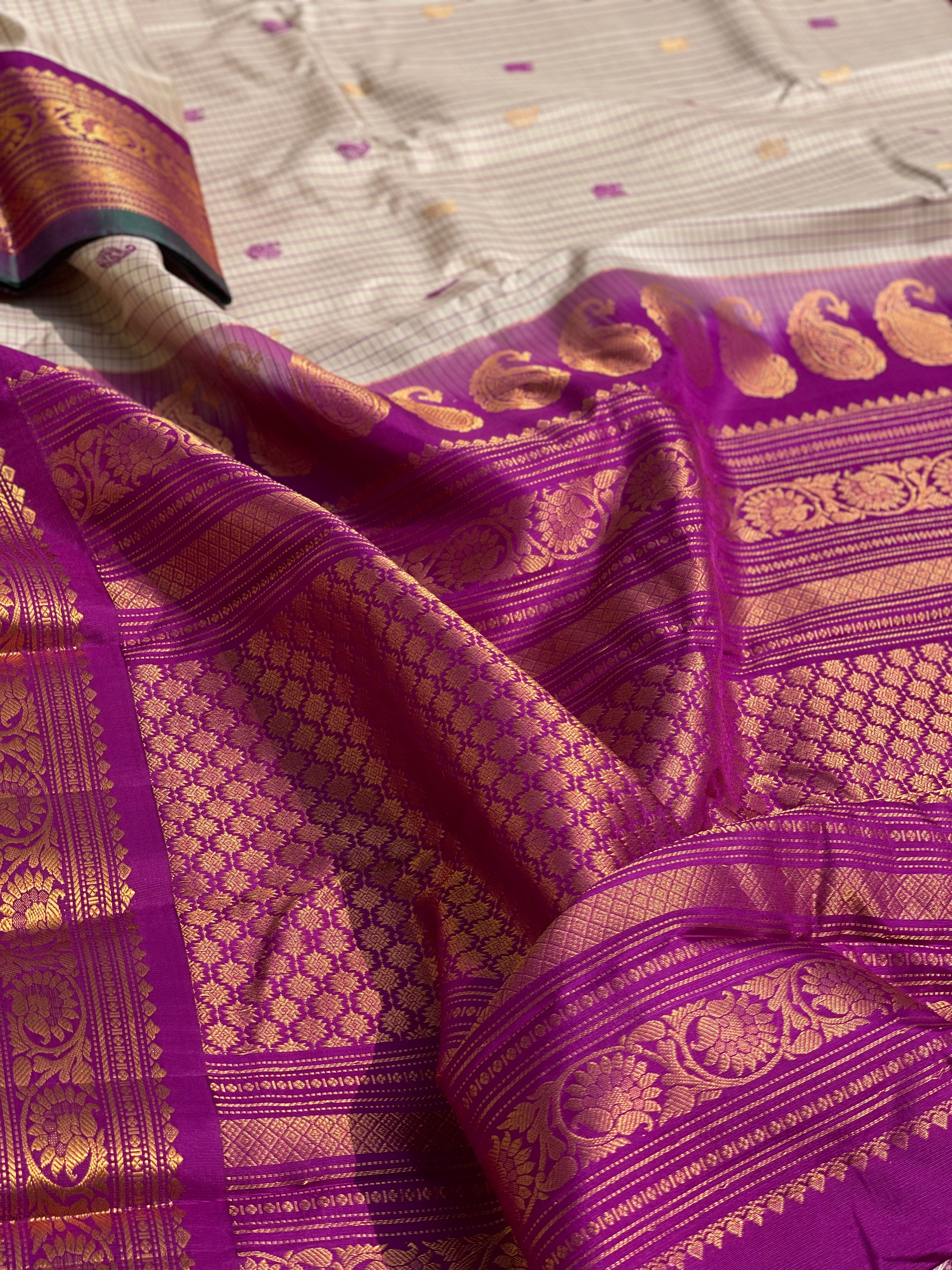 An elegant checks Pearl white with purple Gadwal silk saree