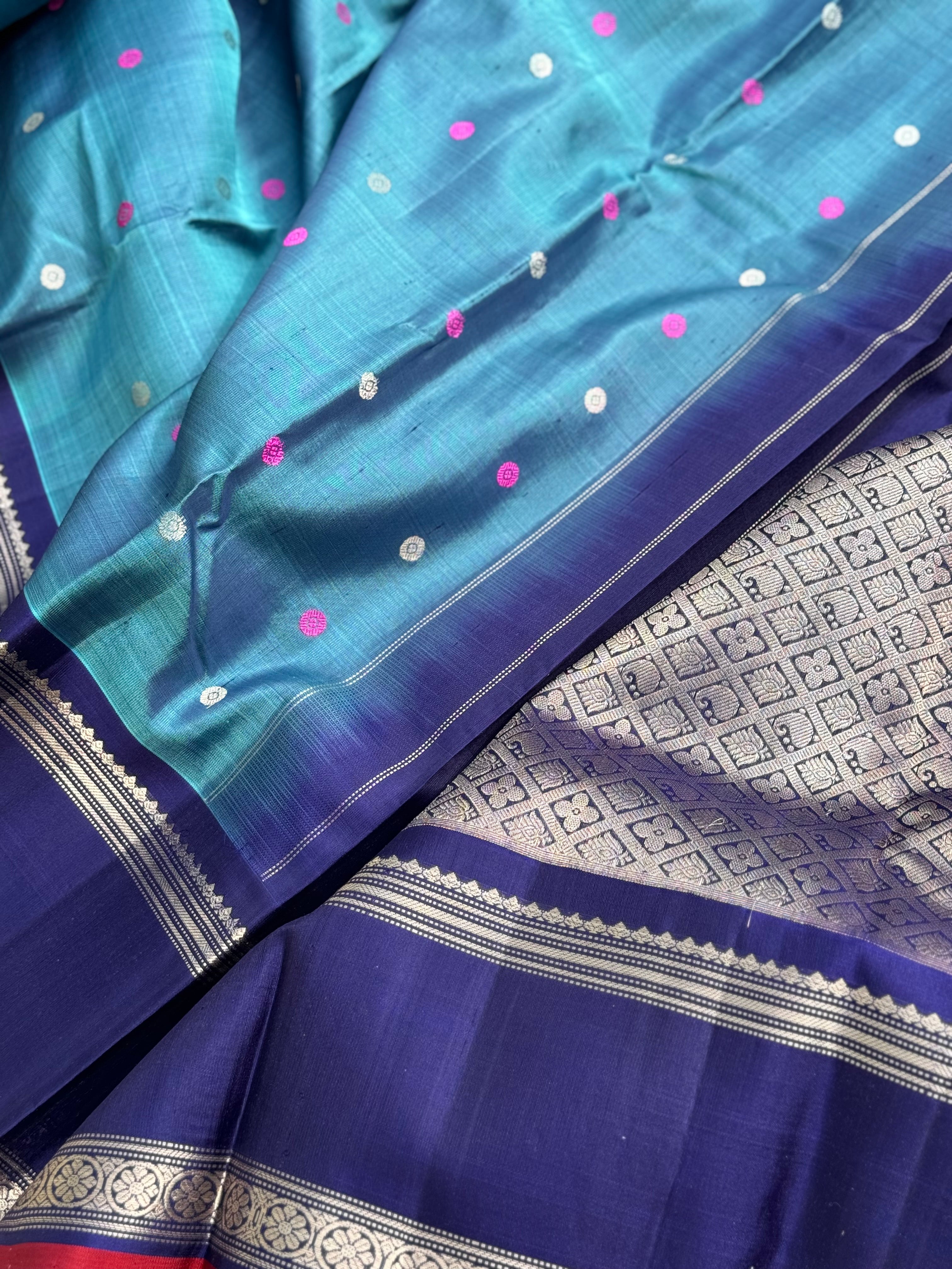 A gorgeous peacock teal handwoven gadwal silk saree