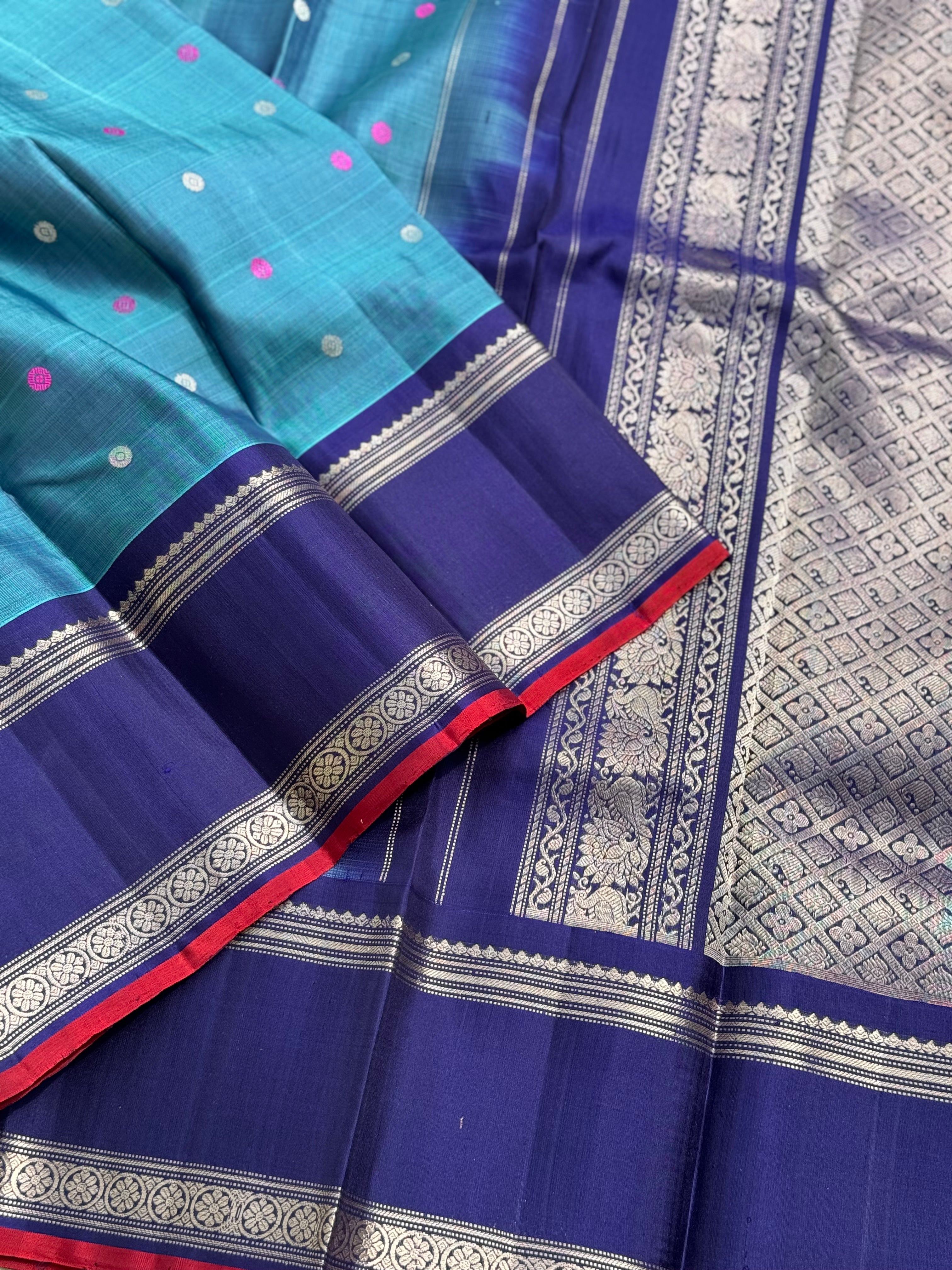 A gorgeous peacock teal handwoven gadwal silk saree