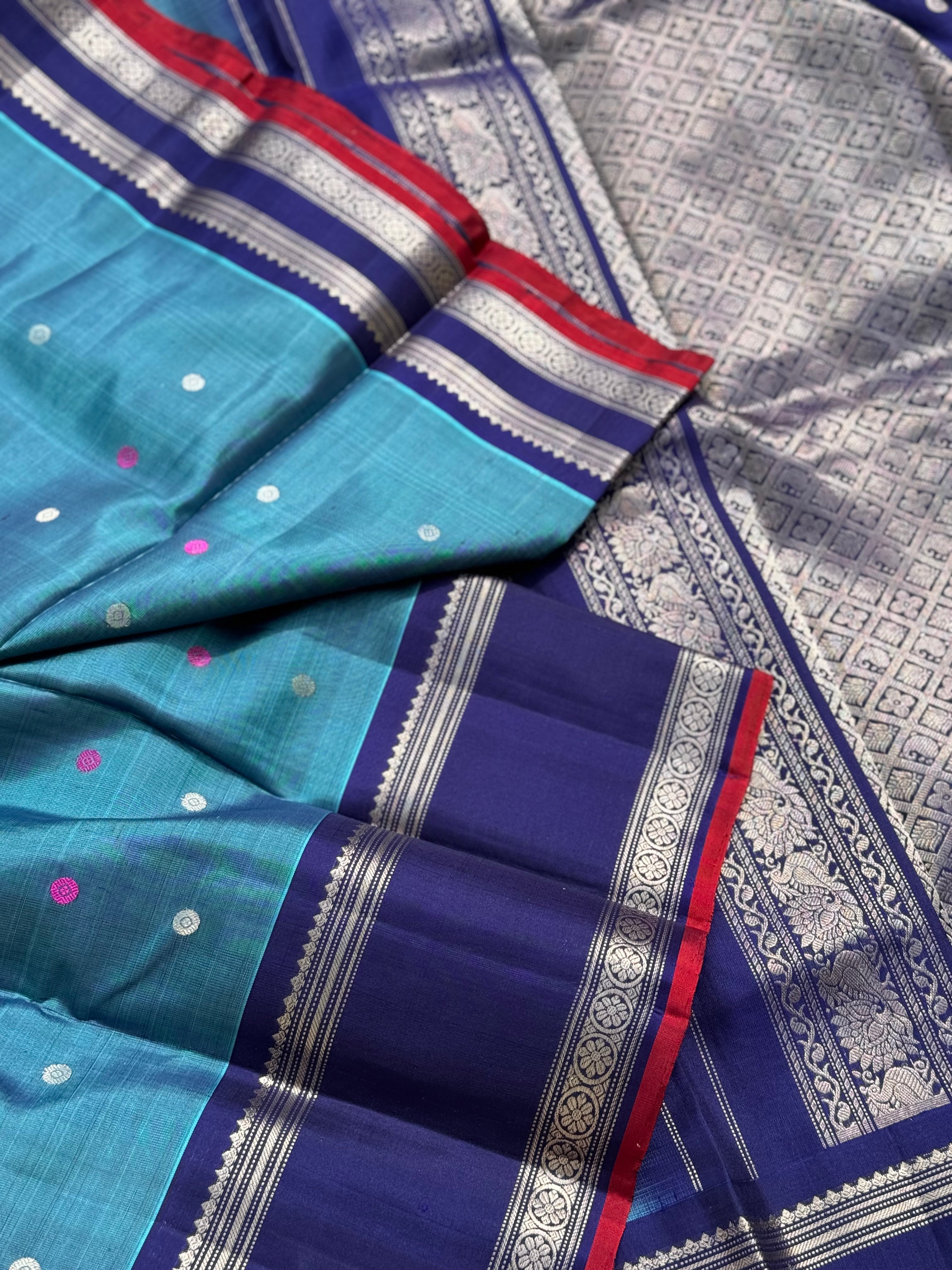 A gorgeous peacock teal handwoven gadwal silk saree