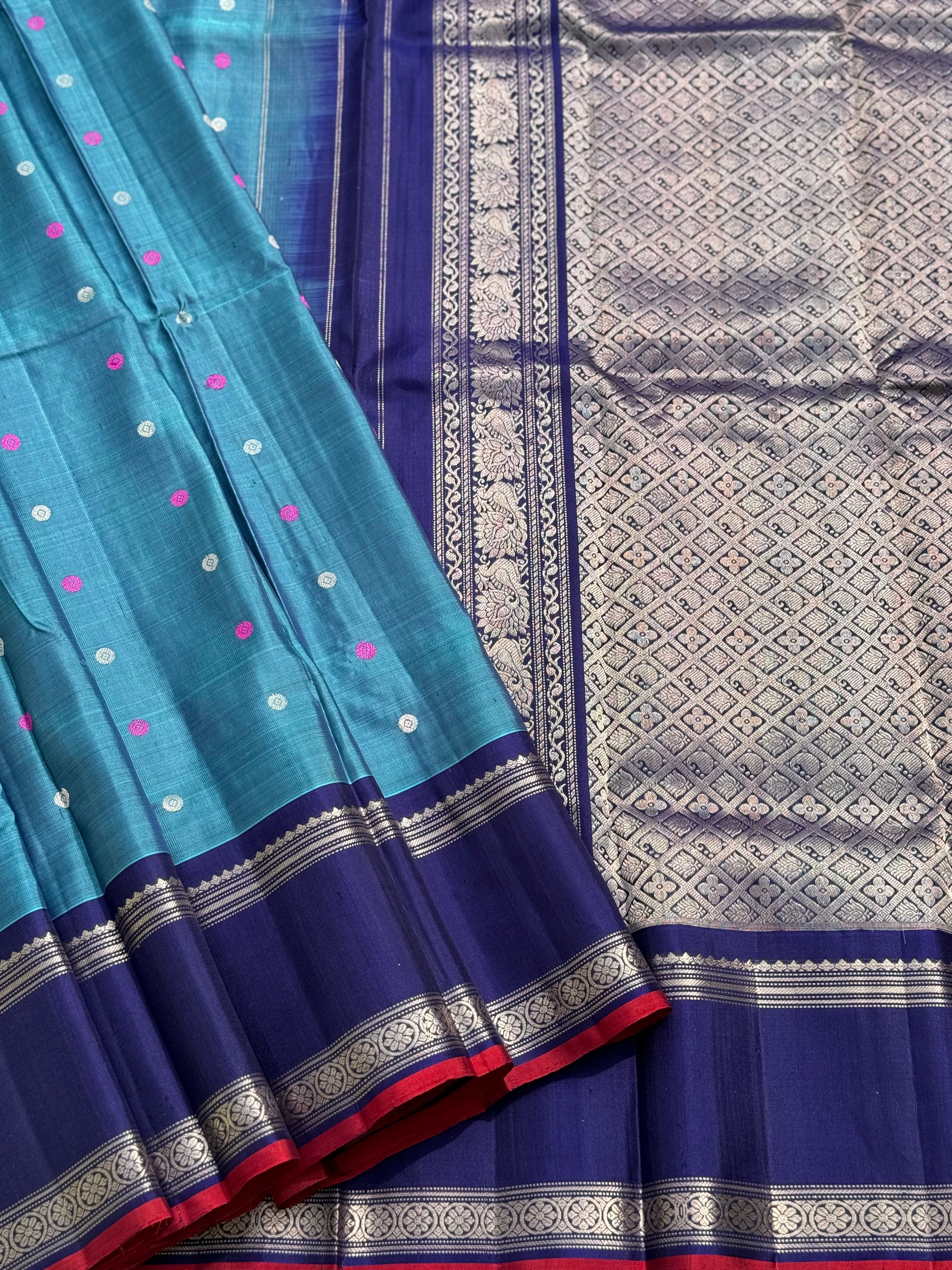 A gorgeous peacock teal handwoven gadwal silk saree