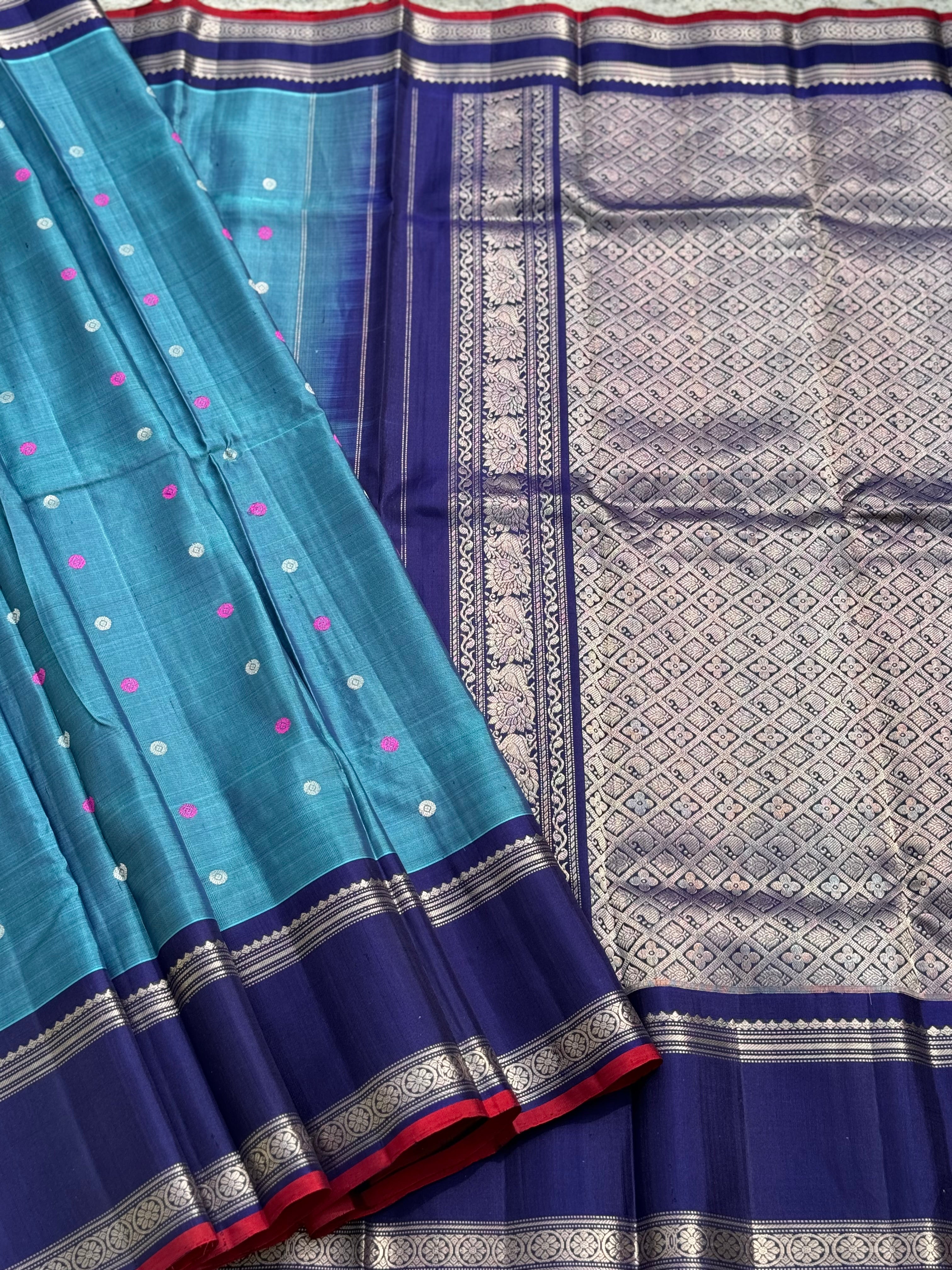 A gorgeous peacock teal handwoven gadwal silk saree