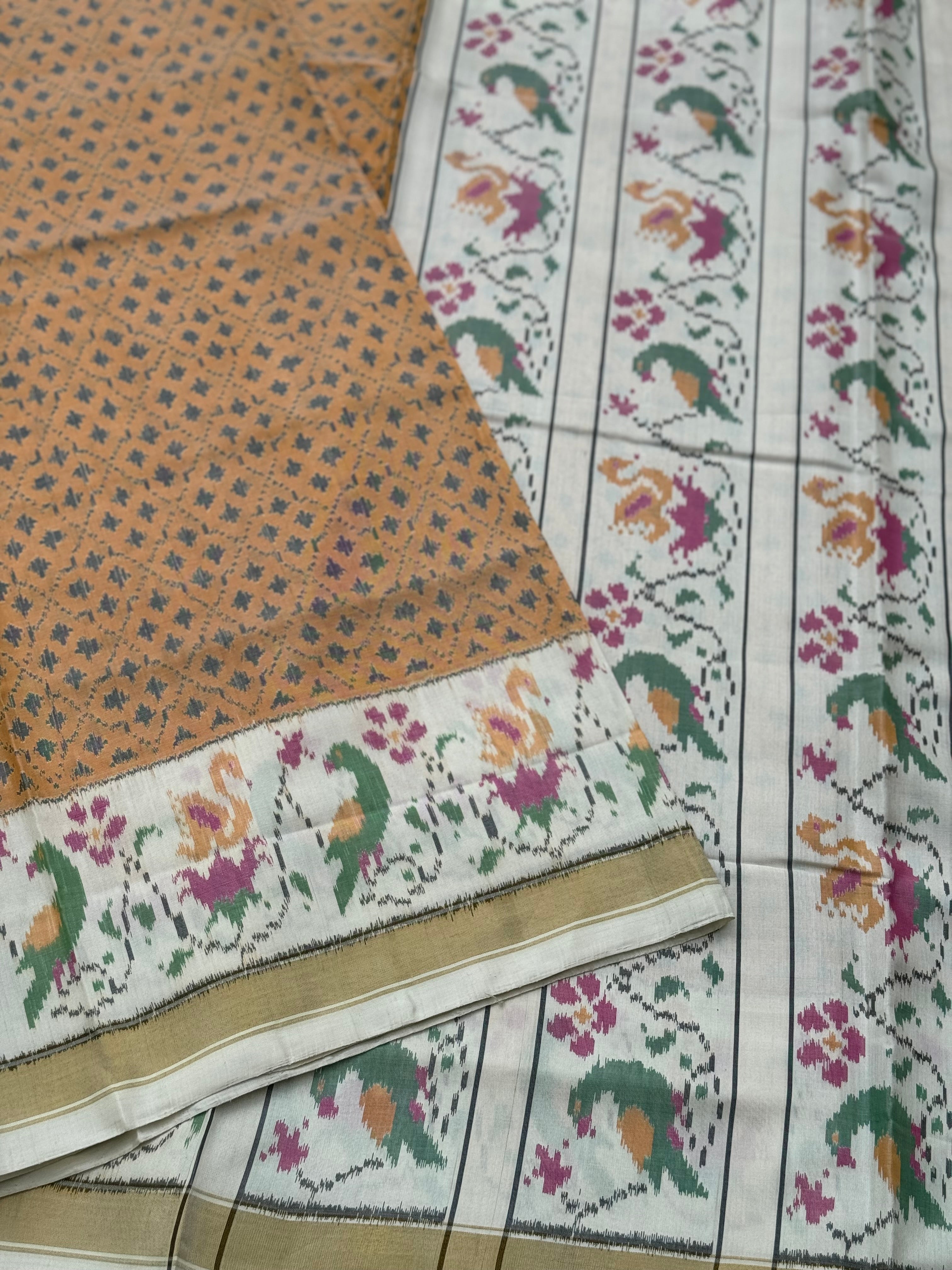 A gorgeous muted gold with offwhite single ikkat patola silk SAREE