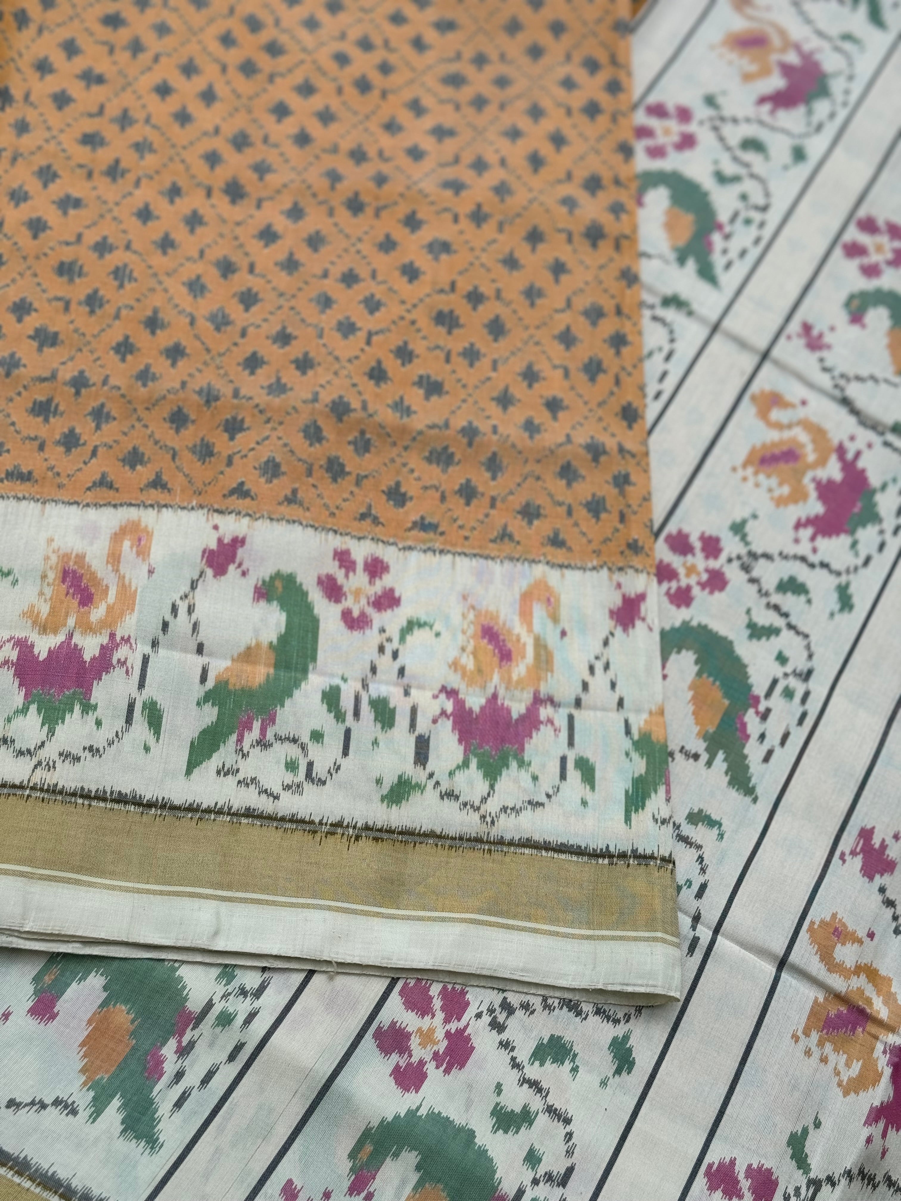 A gorgeous muted gold with offwhite single ikkat patola silk SAREE