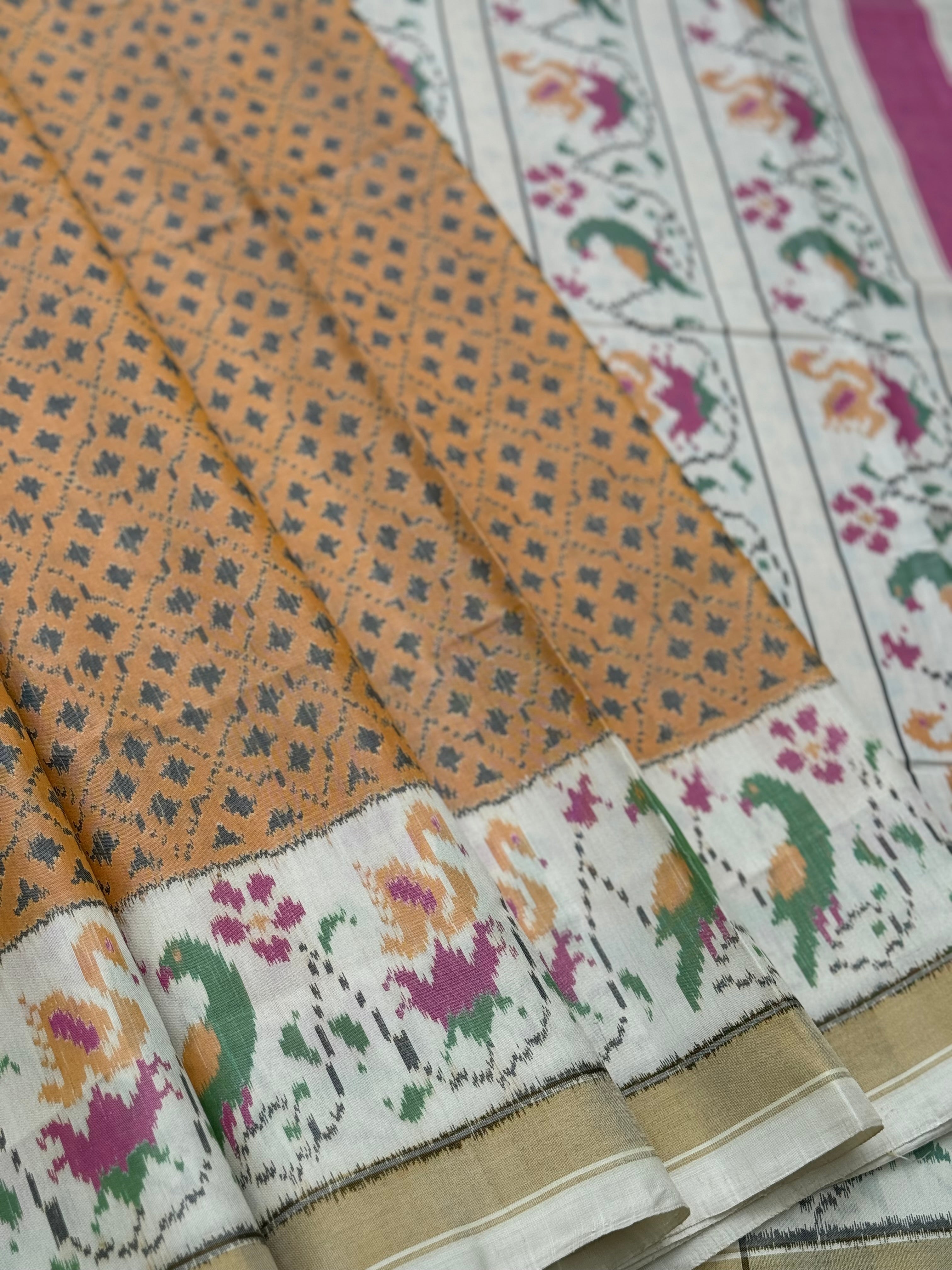 A gorgeous muted gold with offwhite single ikkat patola silk SAREE