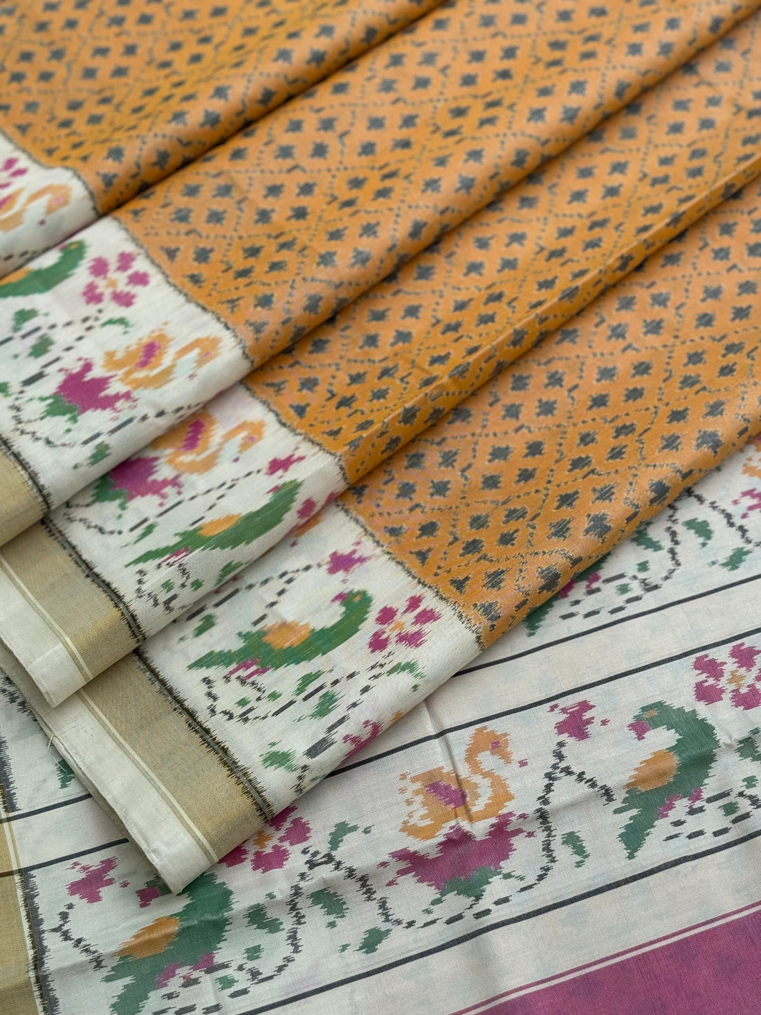 A gorgeous muted gold with offwhite single ikkat patola silk SAREE