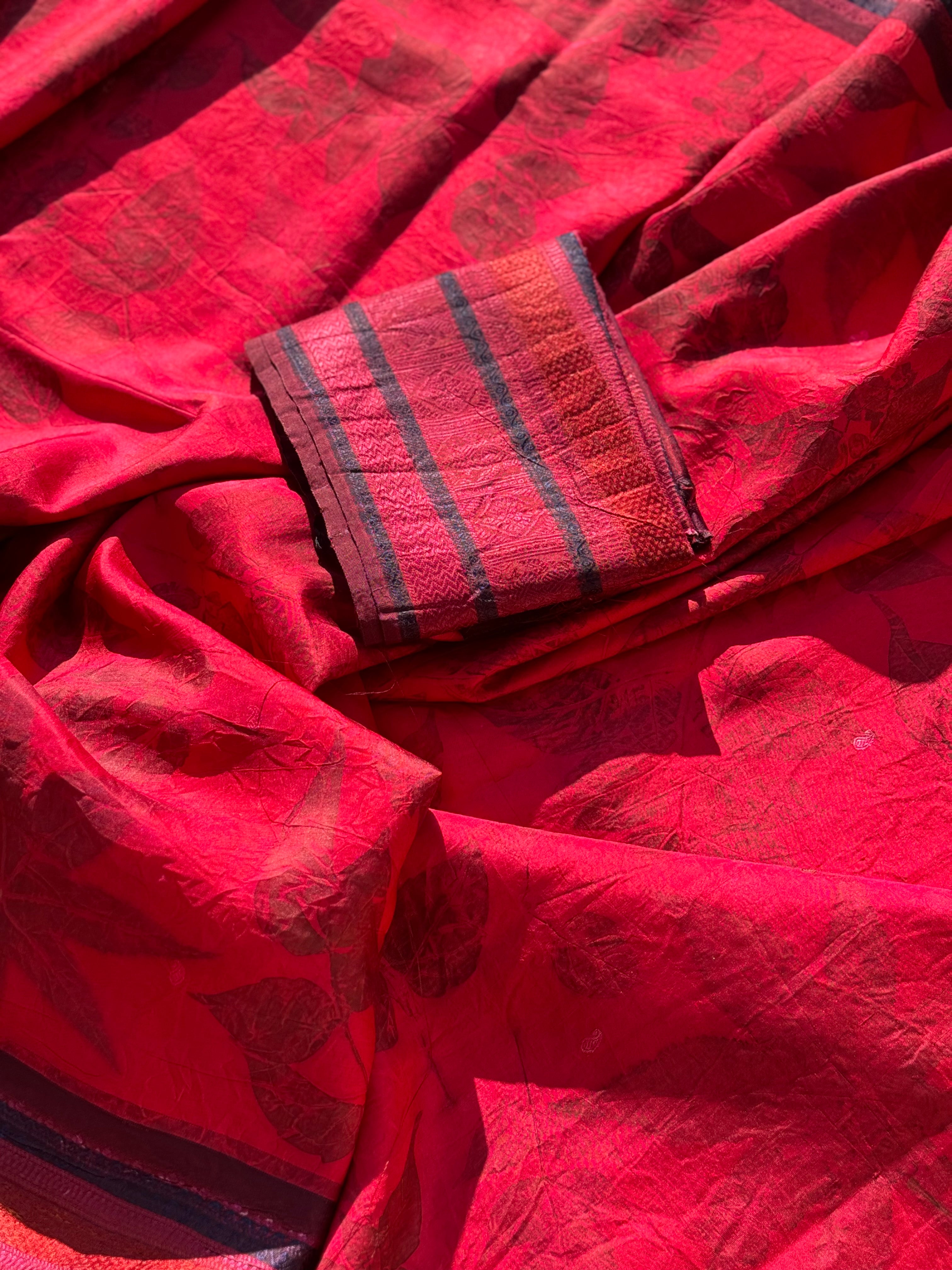 A stunningly gorgeous pinkish red threadwork kanchivaram silk saree with Ecoprints