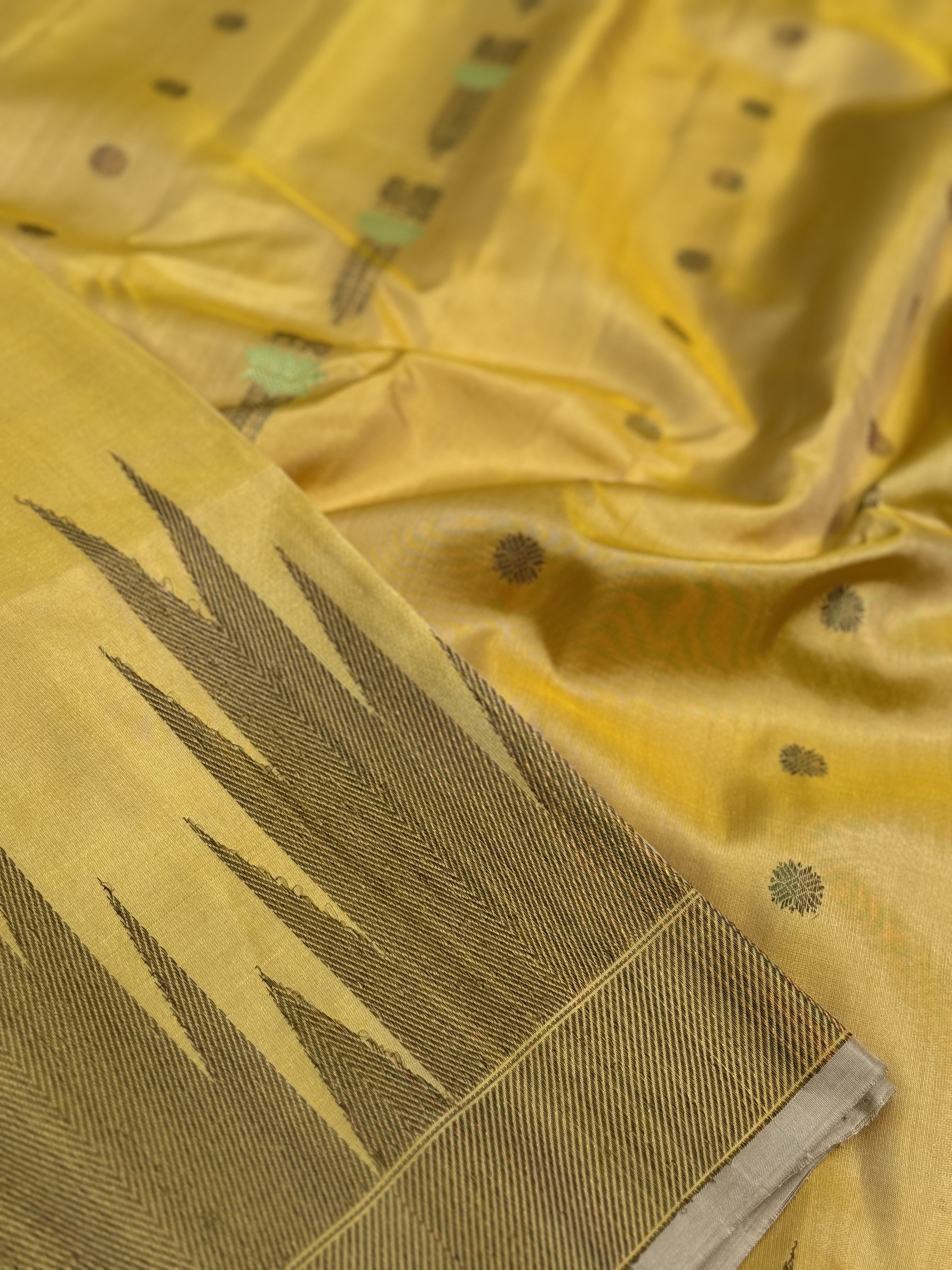 A gorgeous pastel yellow handwoven soft and lustrous temple woven gadwal silk saree
