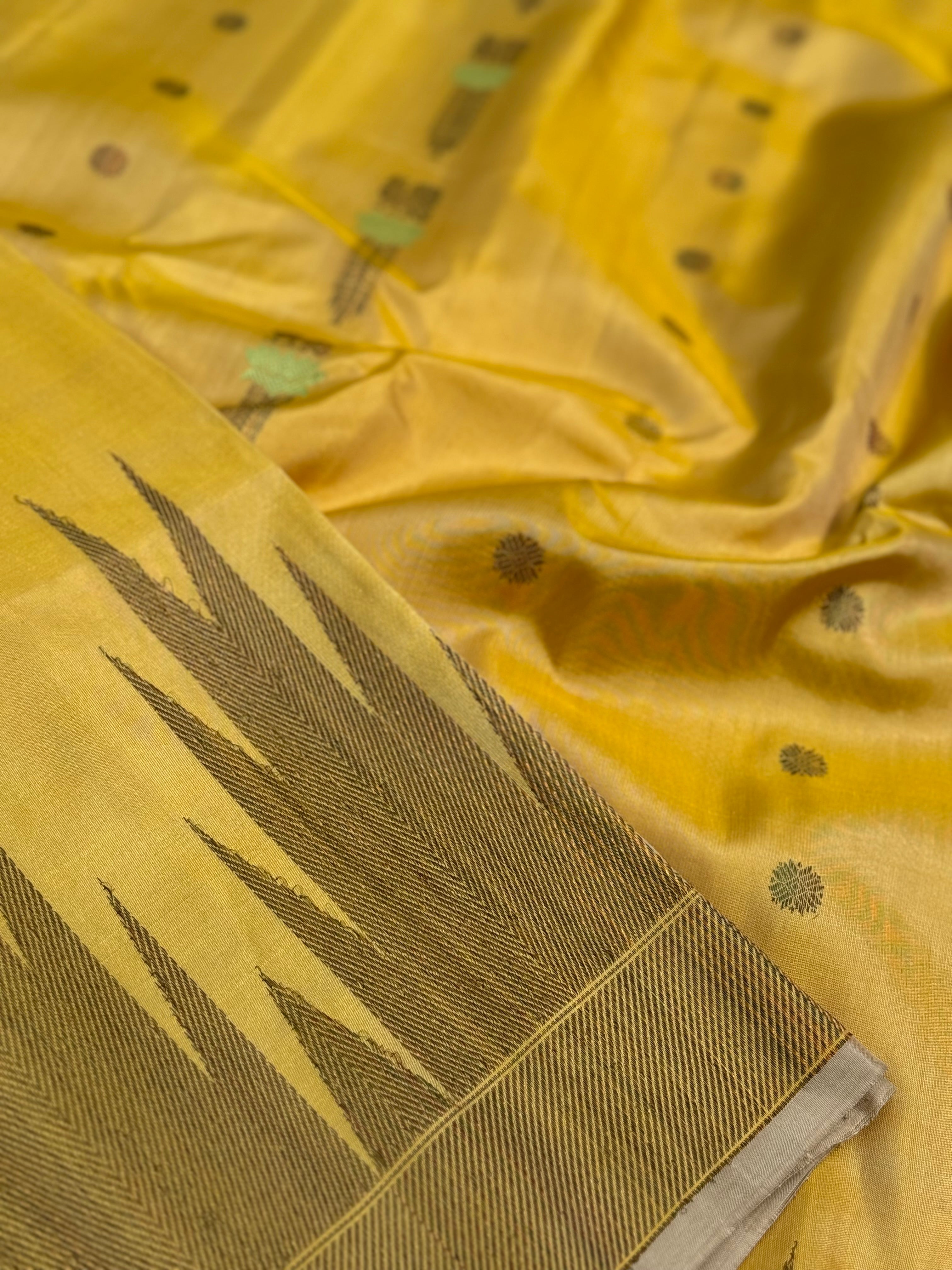 A gorgeous pastel yellow handwoven soft and lustrous temple woven gadwal silk saree