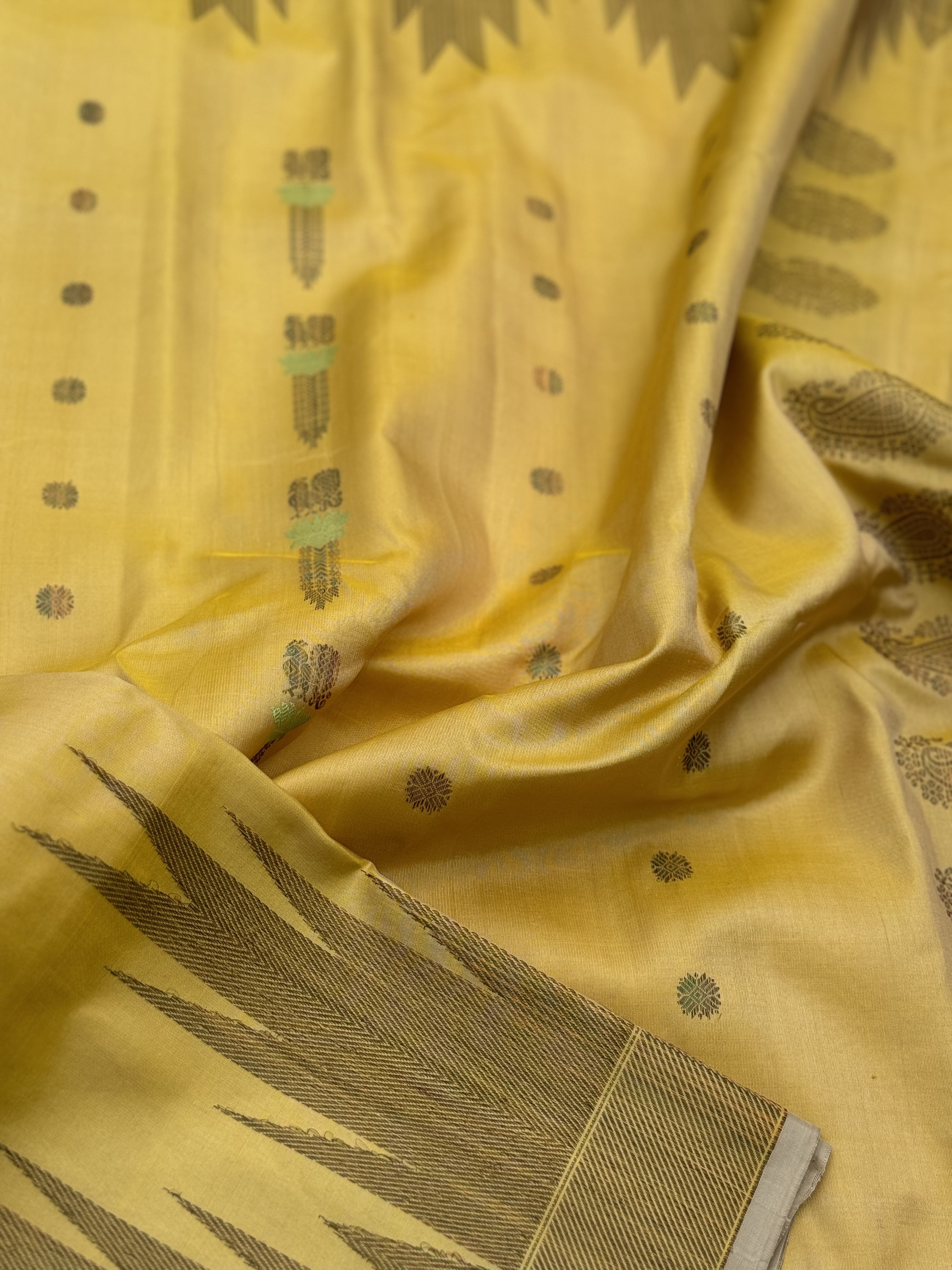 A gorgeous pastel yellow handwoven soft and lustrous temple woven gadwal silk saree