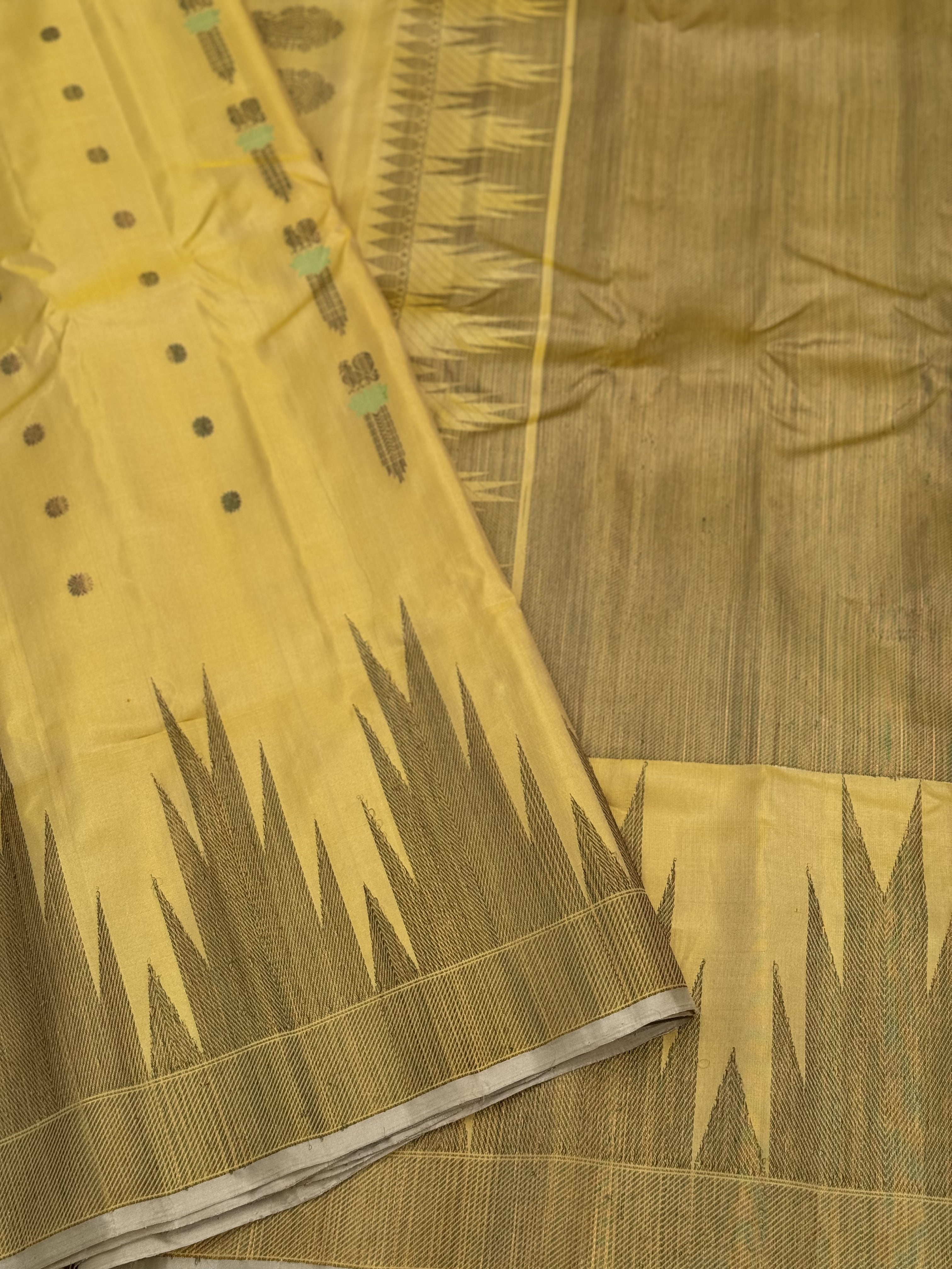 A gorgeous pastel yellow handwoven soft and lustrous temple woven gadwal silk saree