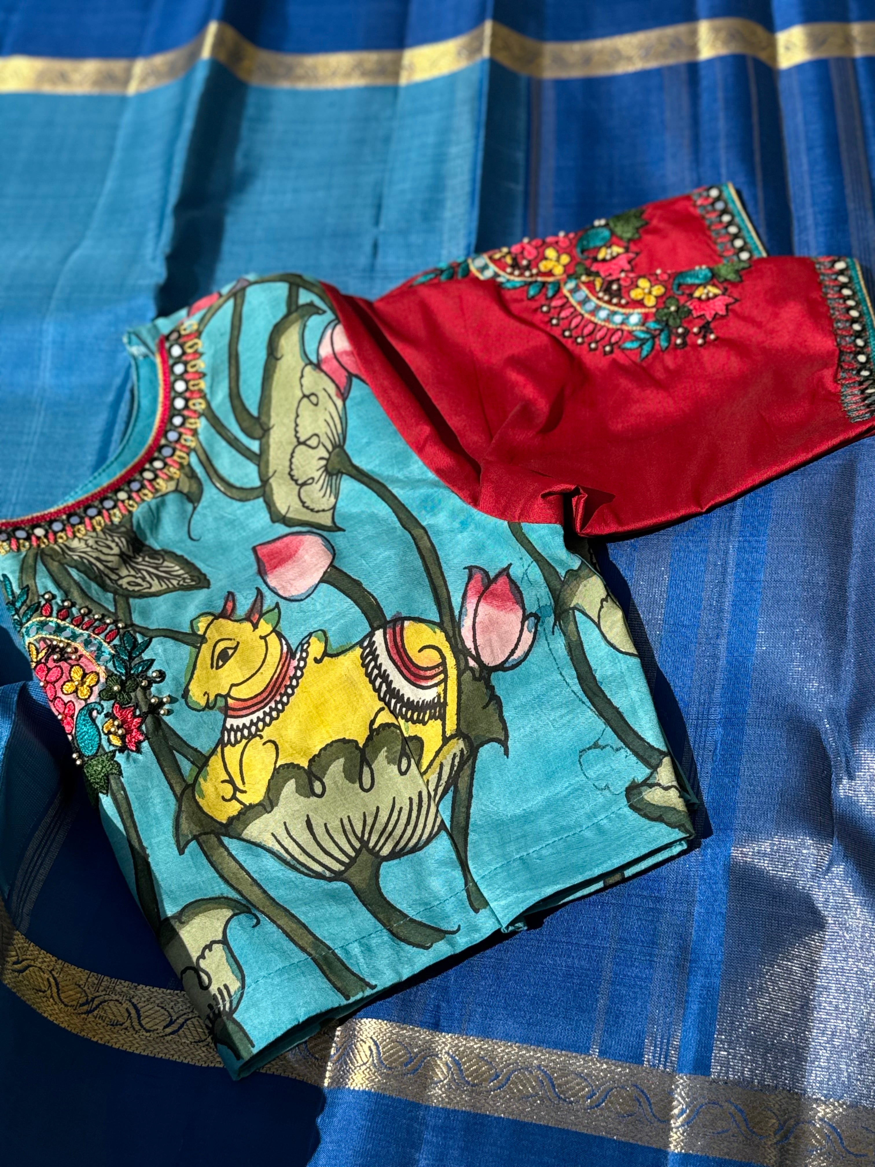 The classy peacock blue with red white silk penkalamkari blouse