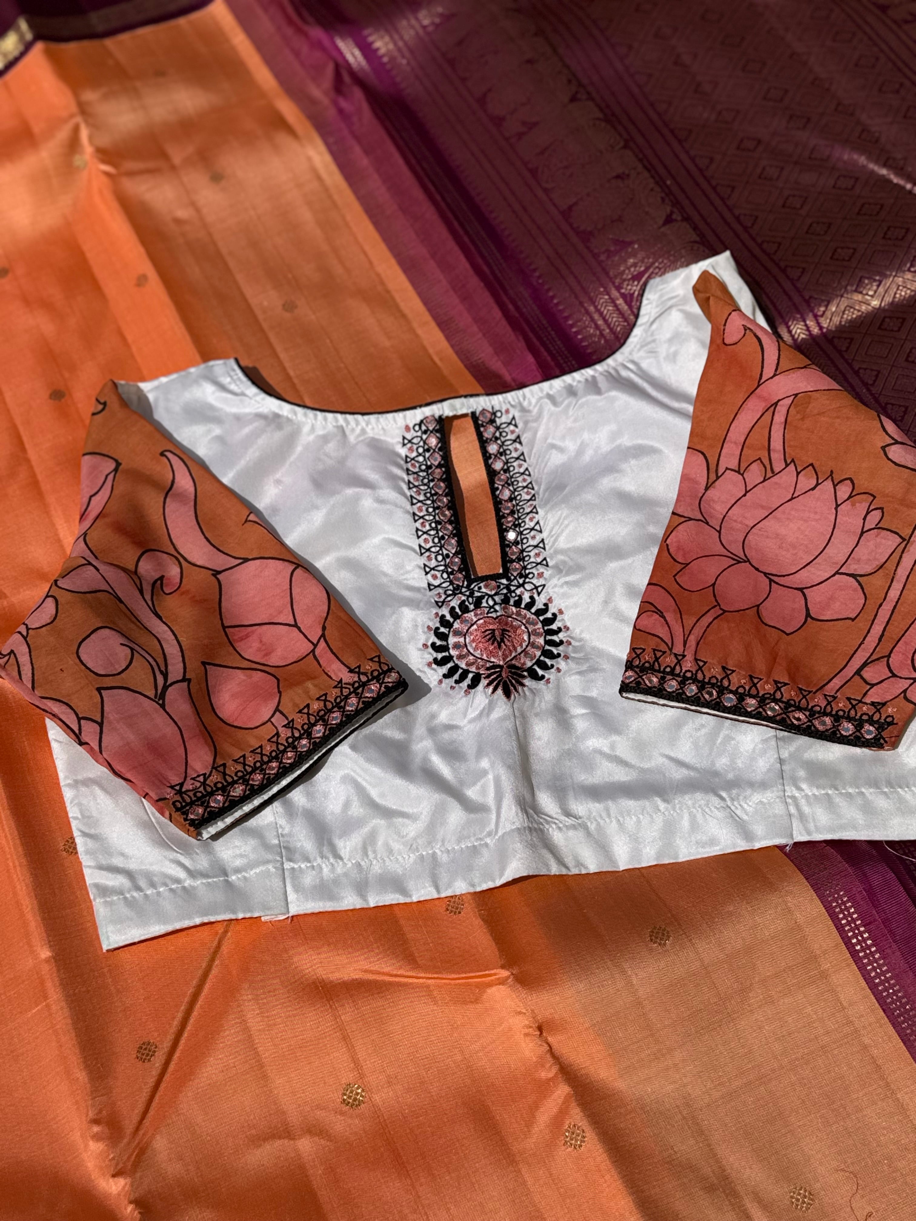 The contemporary style on peach orange with ivory white silk penkalamkari blouse