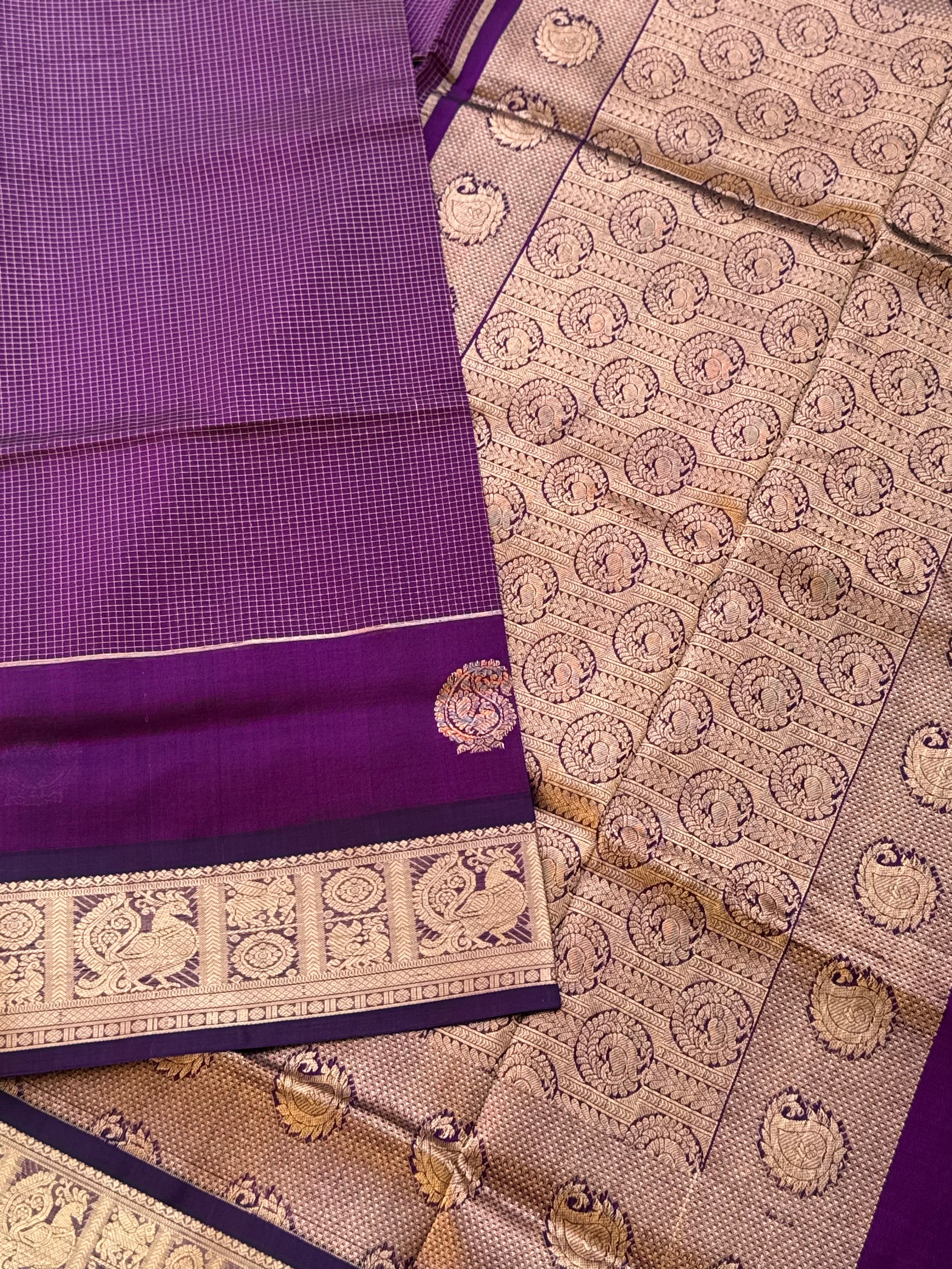 A gorgeous purple shade handwoven Oosi zari checks kanchi silk cotton saree