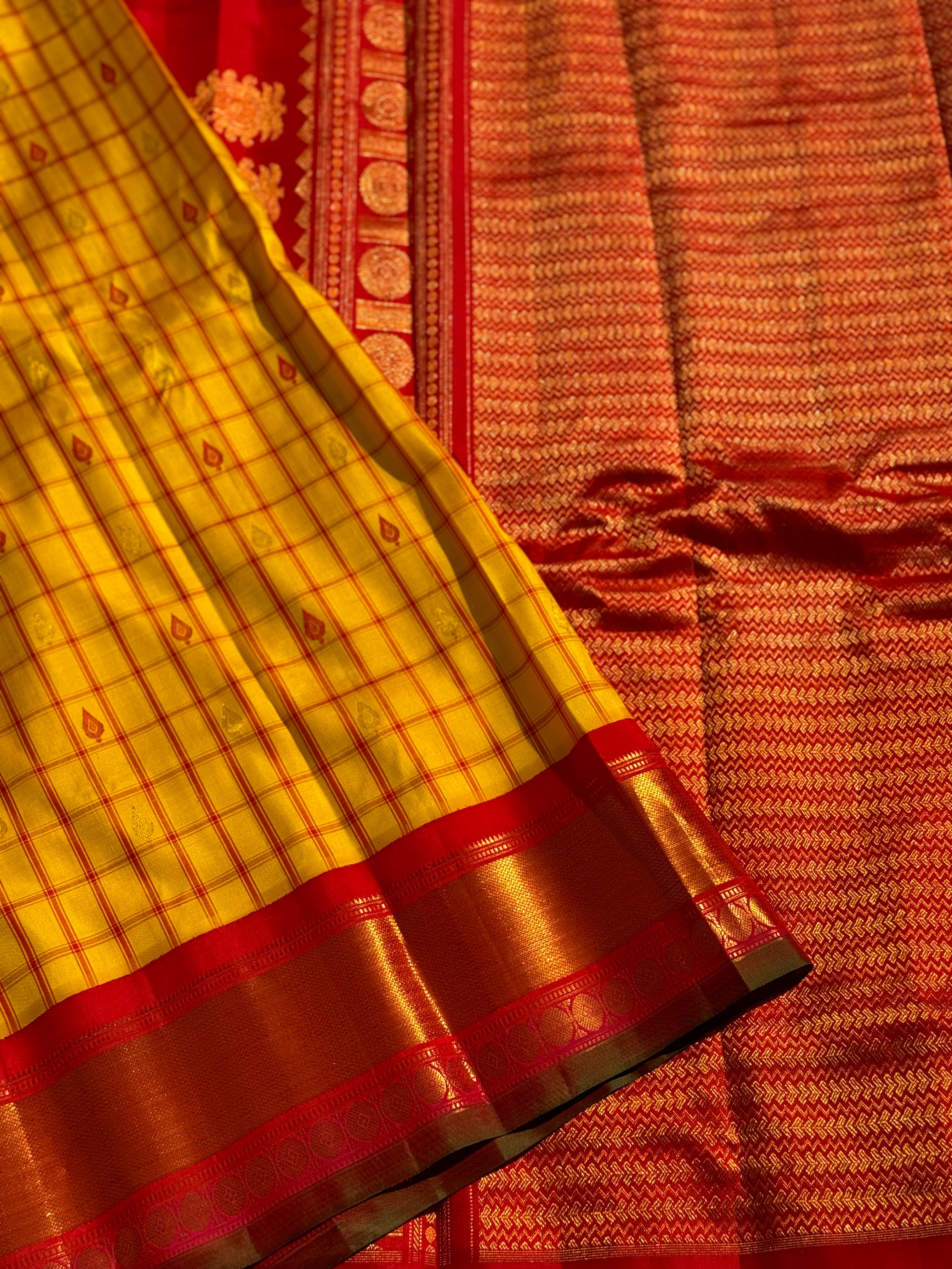 A gorgeous haldi with kumkum red handwoven gadwal silk saree