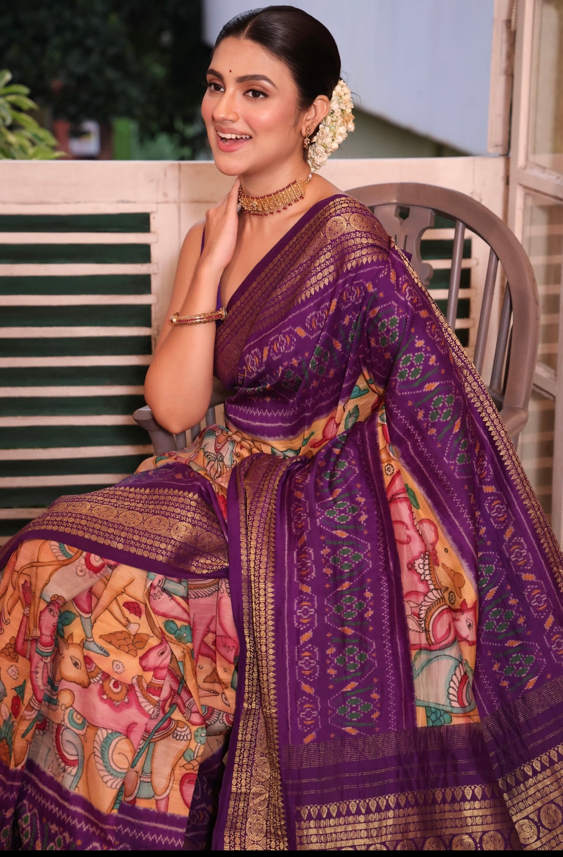 A gorgeous purple shade handwoven ikkat silk saree with kanchi jacquard border adorned with Handdrawn handpainted penkalamkari
