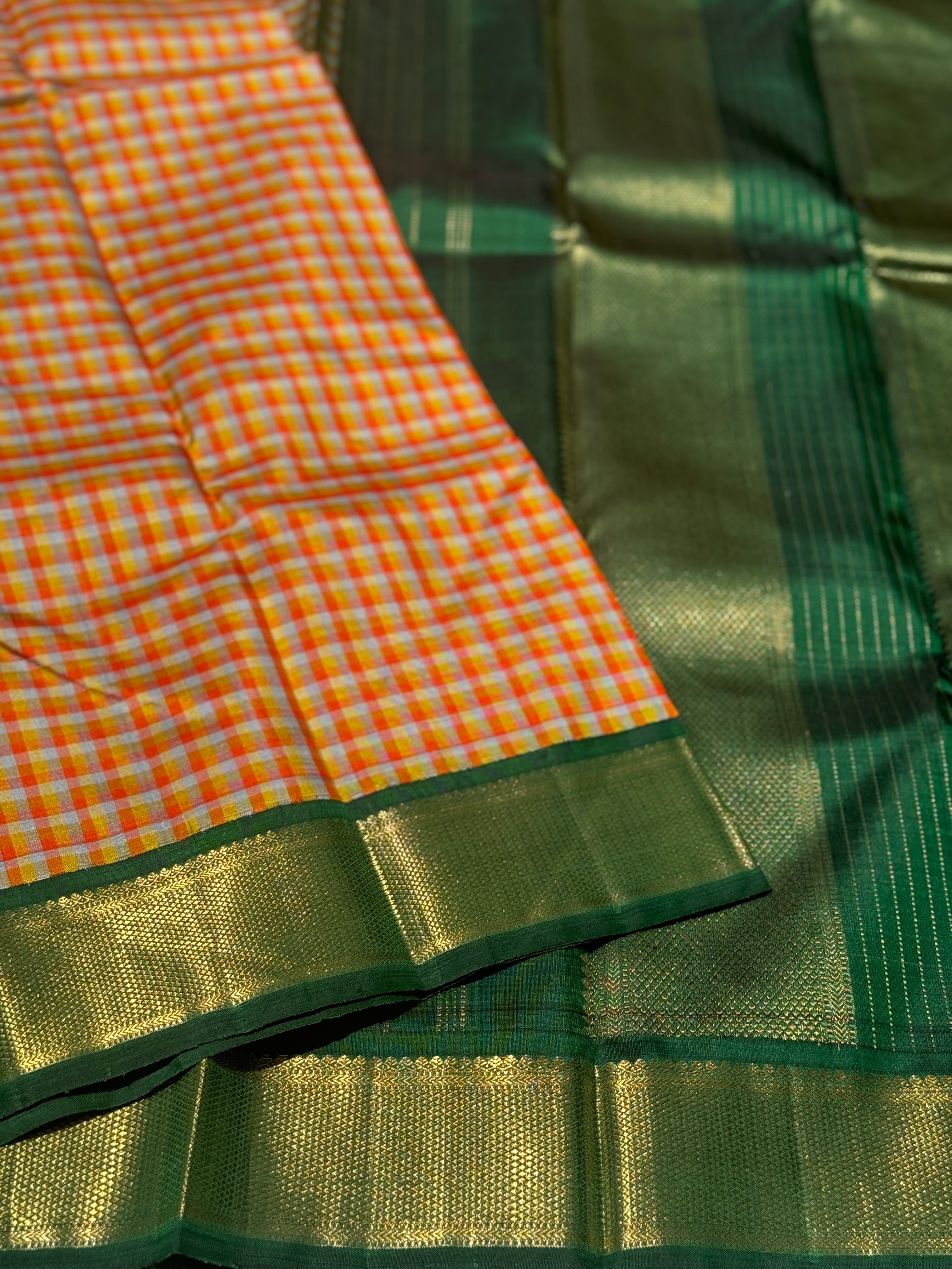 The stunner pastel orange and yellow checks with green shade korvai kanchivaram silk saree