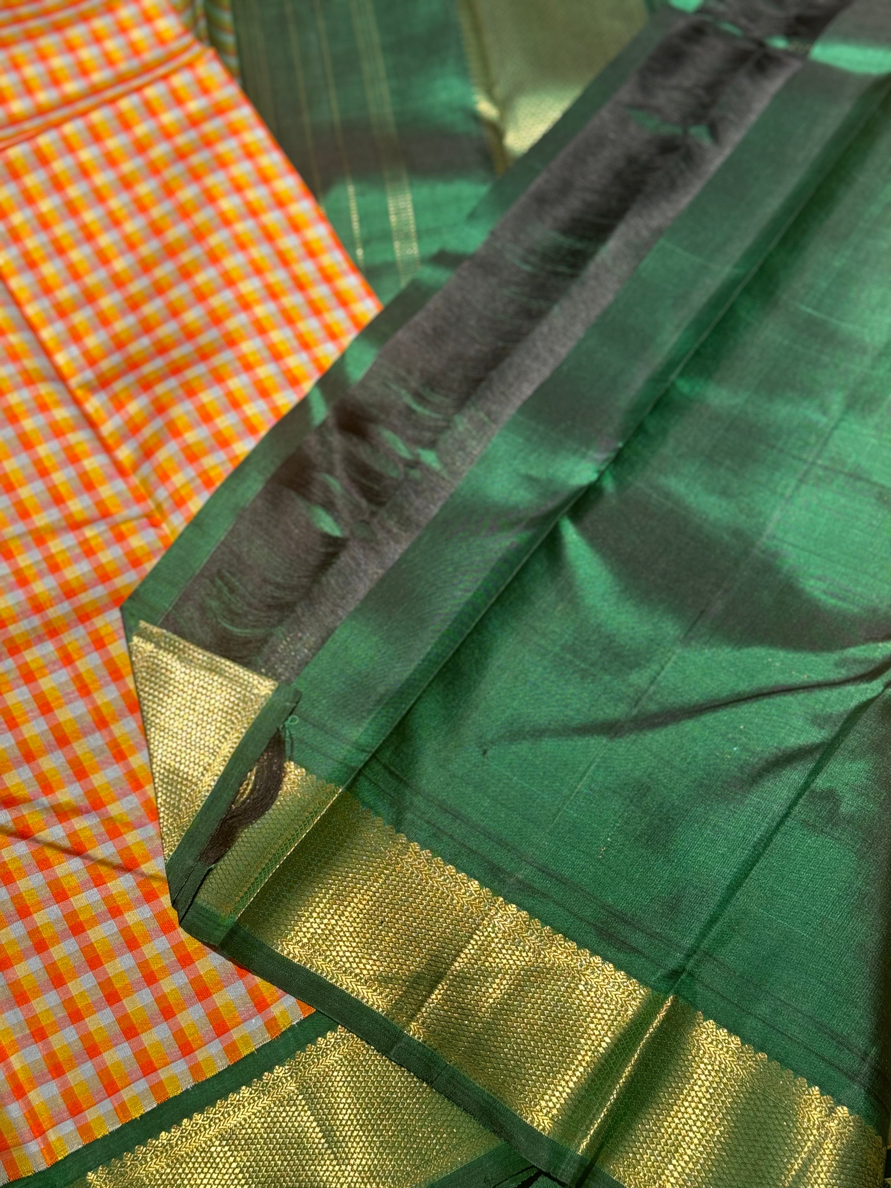 The stunner pastel orange and yellow checks with green shade korvai kanchivaram silk saree