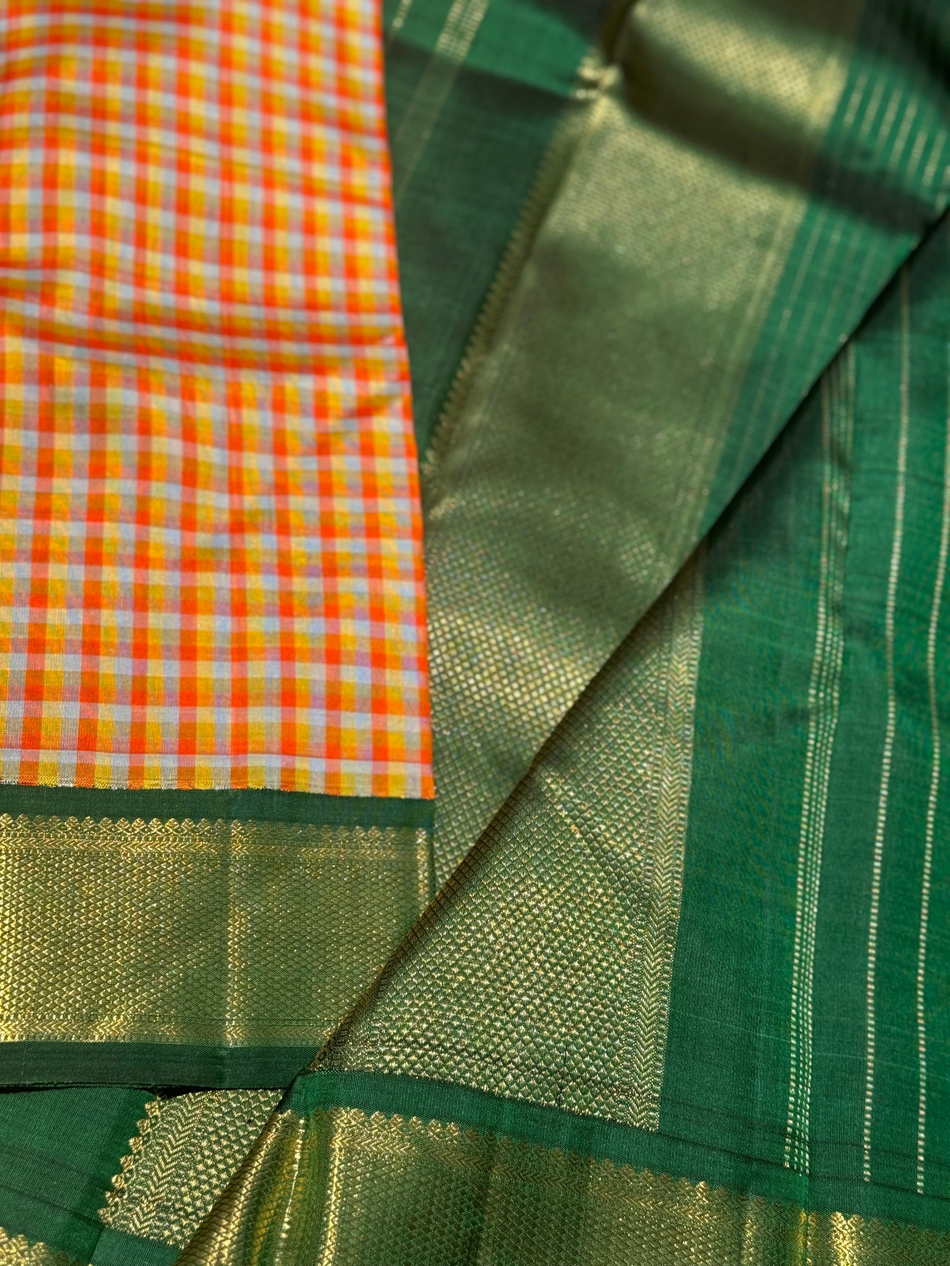The stunner pastel orange and yellow checks with green shade korvai kanchivaram silk saree