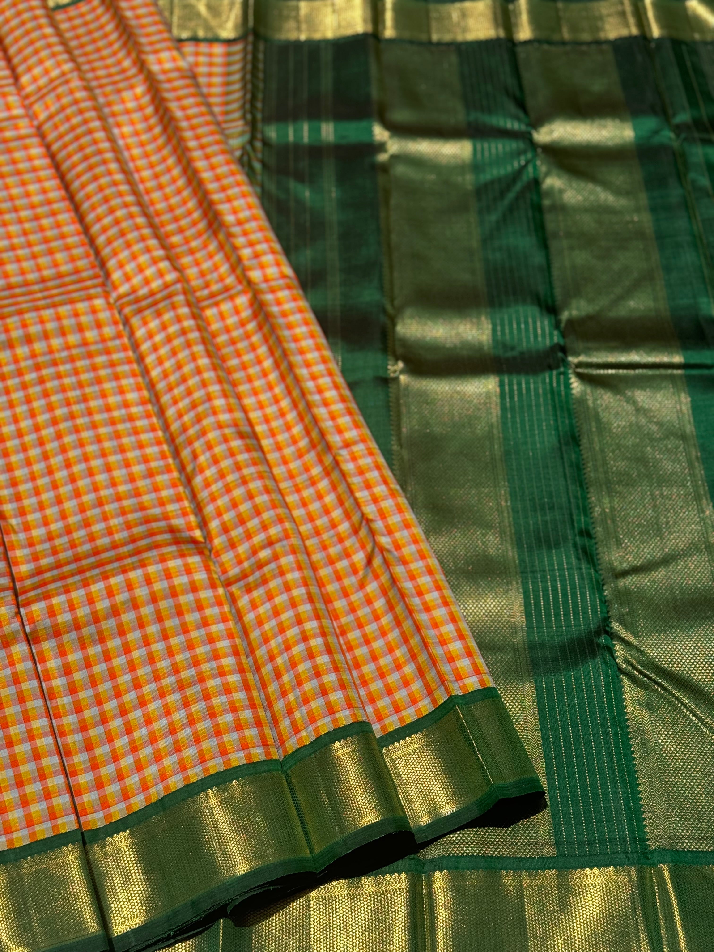 The stunner pastel orange and yellow checks with green shade korvai kanchivaram silk saree